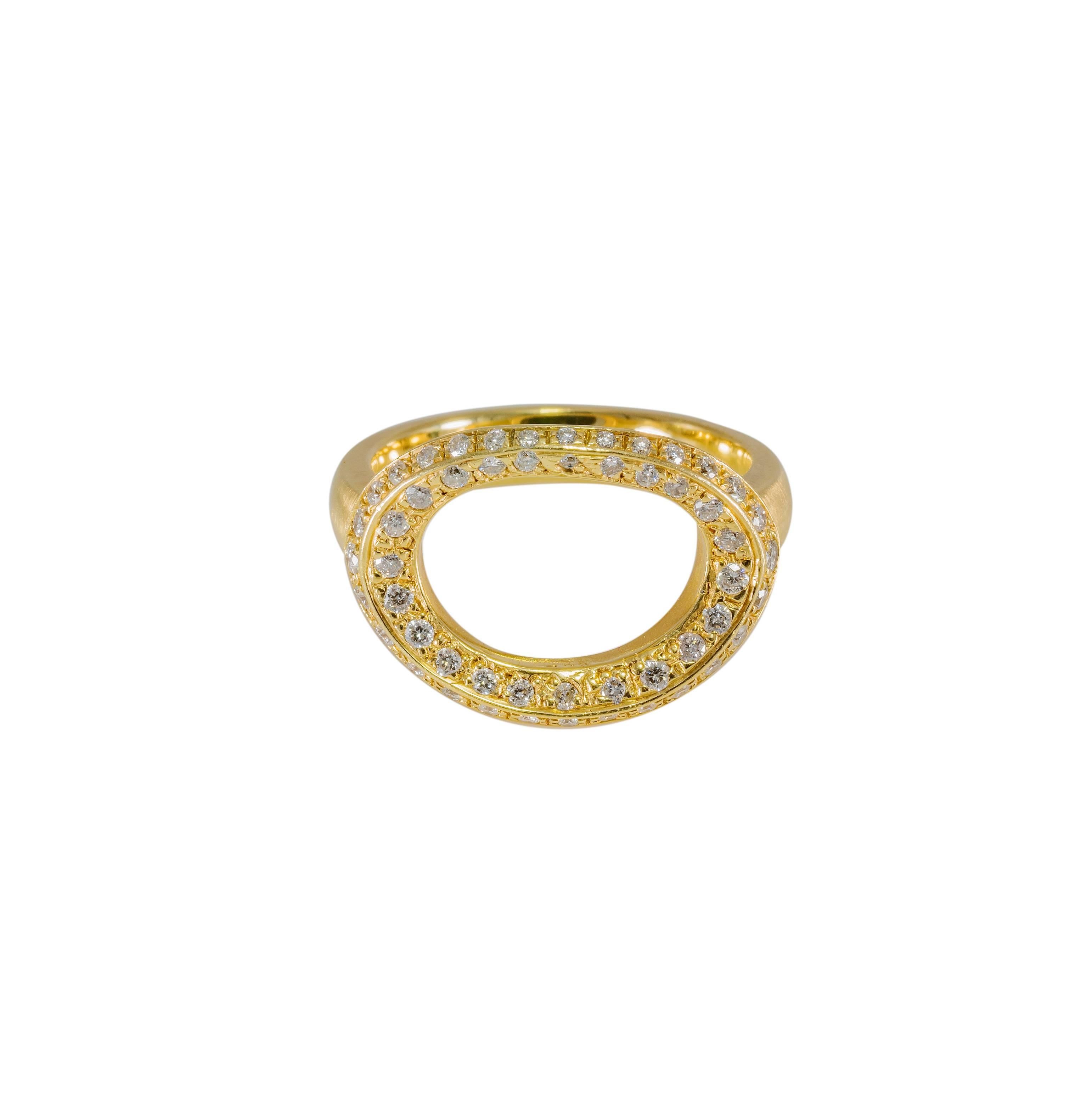 This open oval is set with a multitude of shimmering diamonds to create a stunning modern design. The total weigh of the diamonds is aprox. 1.33 tw. The ring is a size 7.  The open oval is curved to the shape of your finger for maximum comfort and