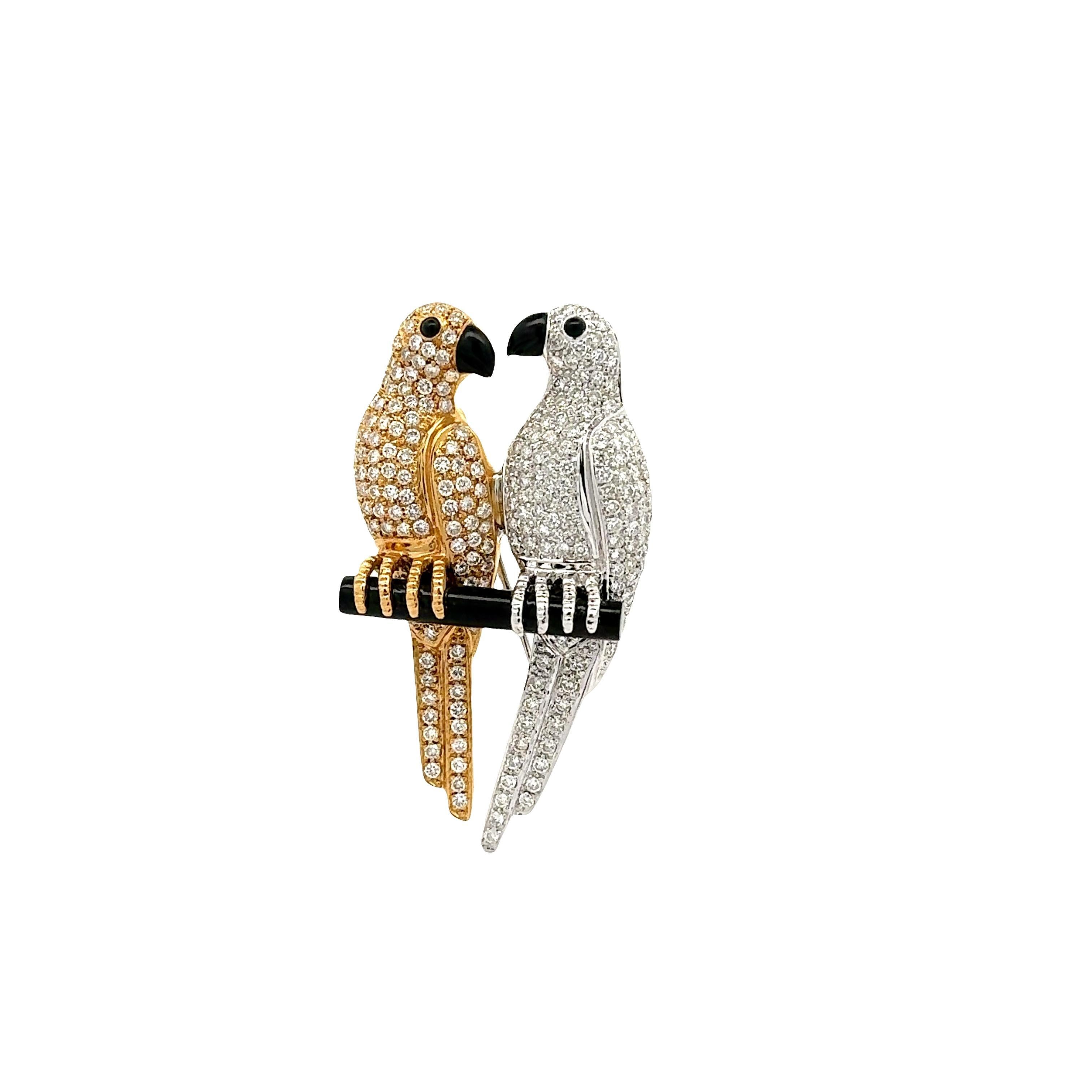 Une broche captivante représentant des oiseaux amoureux perchés l'un sur l'autre. Les amoureux sont incrustés de 2,70 carats de diamants blancs ronds, créant un effet éblouissant. Les yeux et les becs sont rehaussés d'onyx noir, ce qui ajoute de la