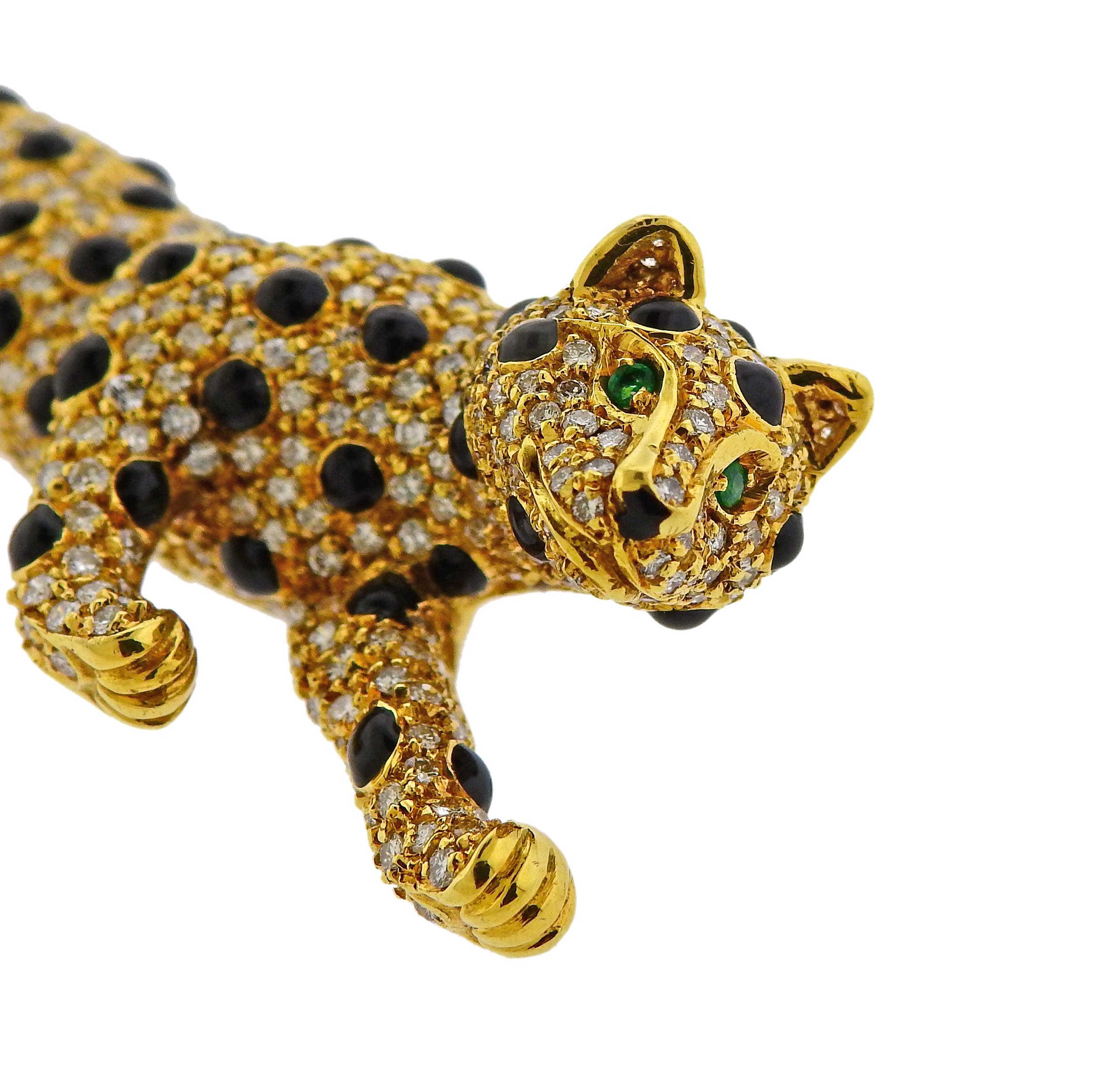 18k yellow gold panther brooch, decorated with emerald eyes, onyx and approx. 1.40ctw in diamonds. Brooch measures 78mm x 24mm, weighs 27.5 grams. Marked 750 and with an Italian mark. 