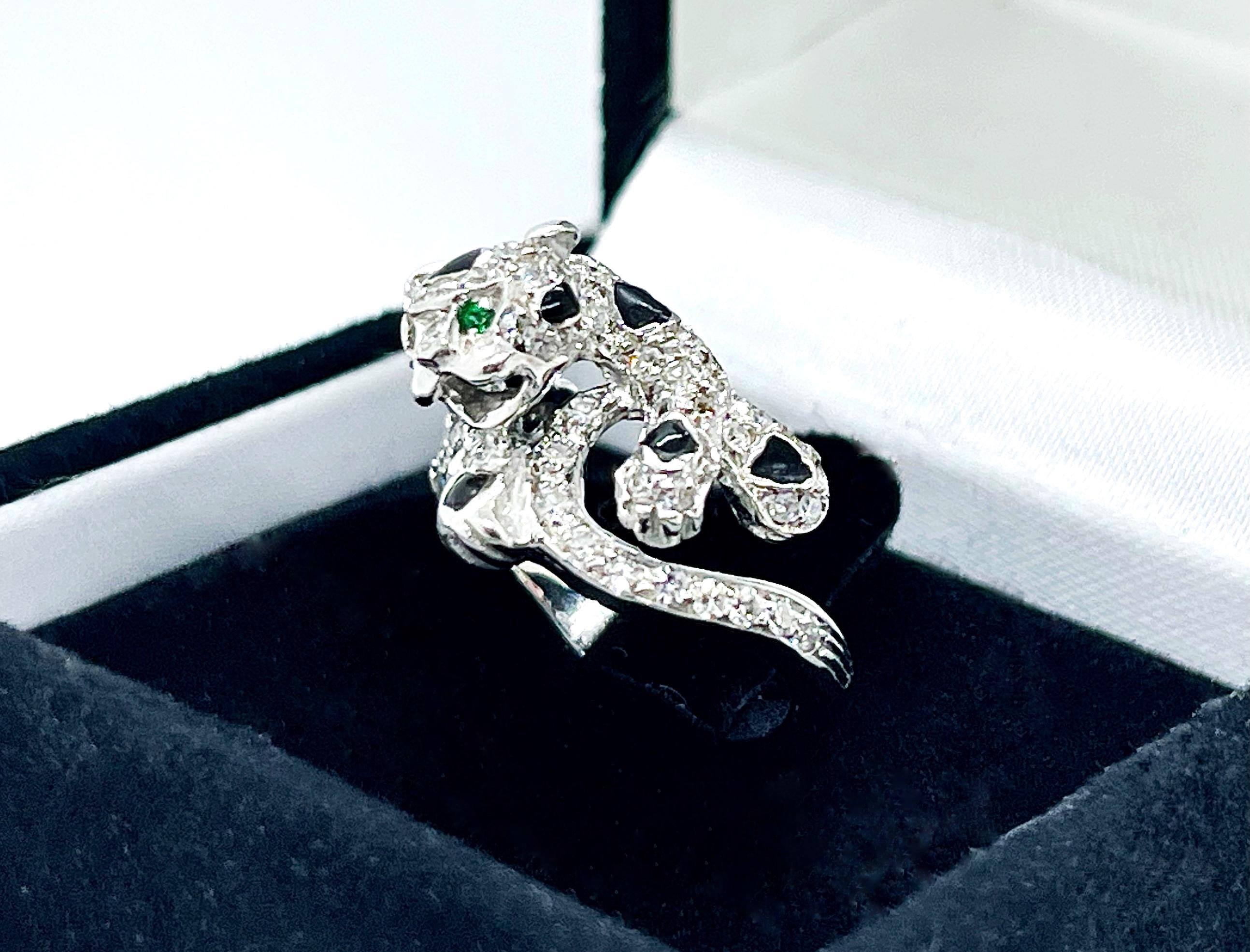 An extraordinary gorgeous cocktail ring, inspired by the famous Cartier Panther ring. The ring is paved with diamonds, onyx and emeralds. It represents a panther which surrounds your finger and ready to jump.  A custom made ring, created by the