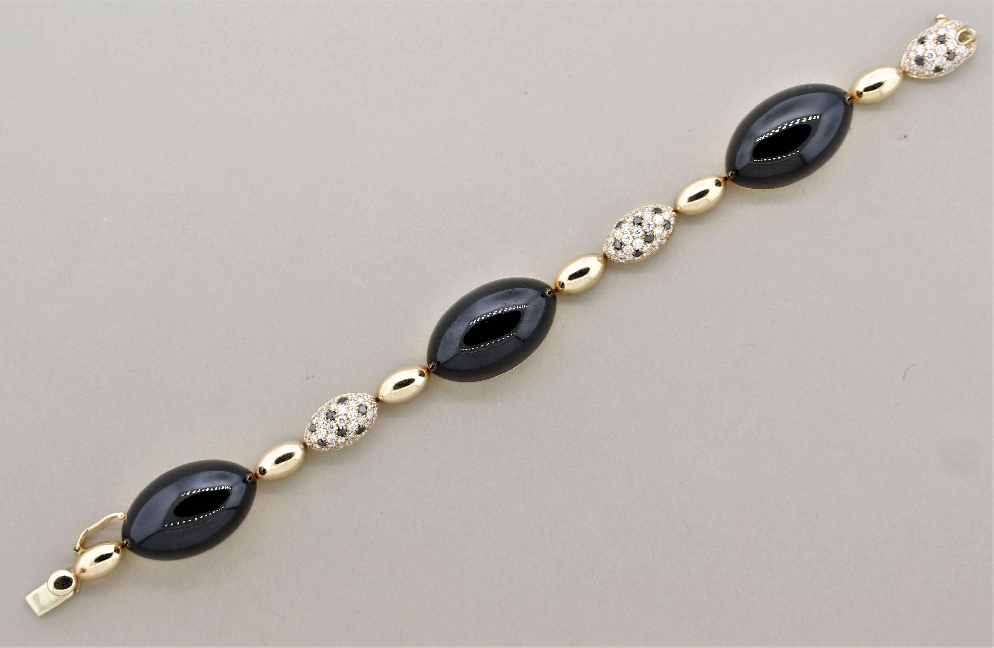 A wonderfully styled bracelet featuring white & black diamonds, onyx and brilliant contrast. There are 2.18 carats of fine white diamonds along with 0.57 carats of fancy black diamonds set together on 3 gold partitions. Between them are 3 large