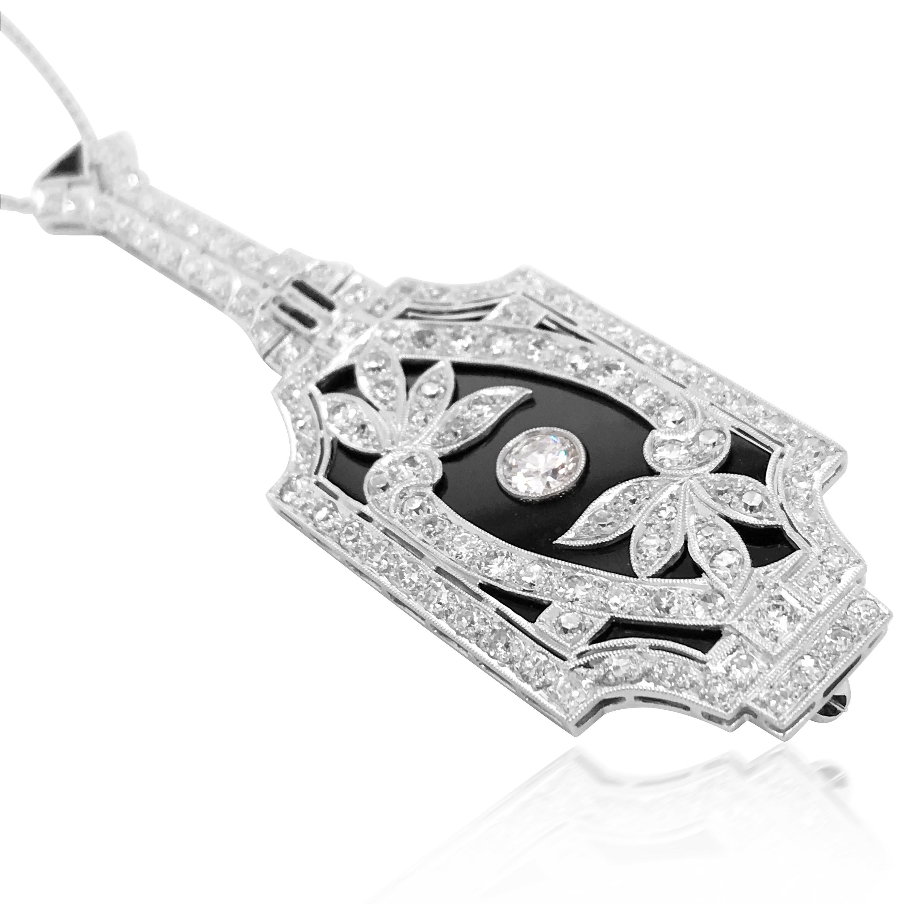 This exquisite diamond and onyx pendant is rendered in solid platinum. The pendant is shaped like a musical instrument and is centered with a 0.5ct round diamond. The flowers composed of other diamonds weighing approx. 2ct in total are classic with