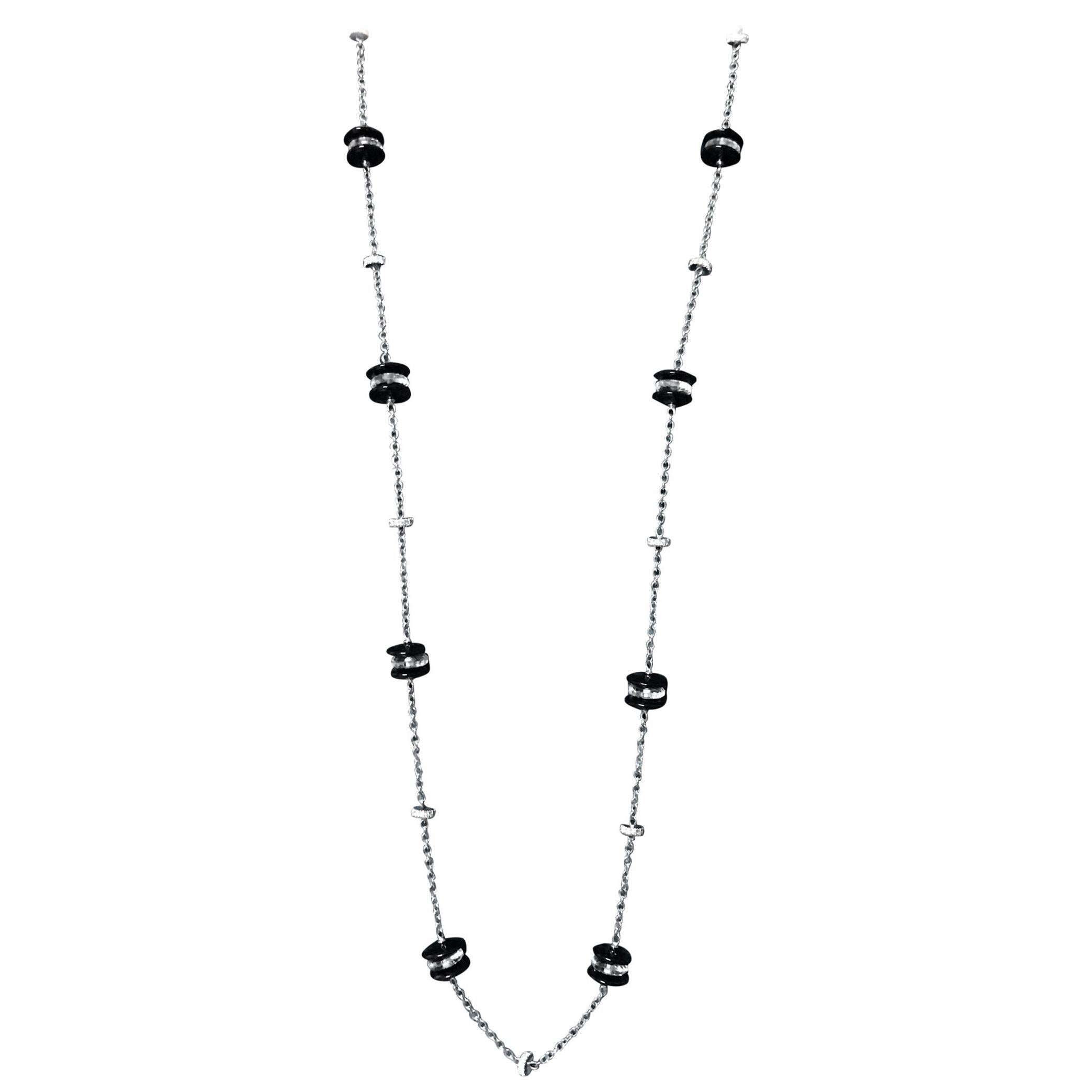This elegant long necklace has been designed and  handcrafted in Italy, in Margherita Burgener family workshop.
The 18 KT white gold rolò chain is decorated by onyx rondels, faceted rock crystal rondels and  diamond spacers. 
Can be worn doubled,