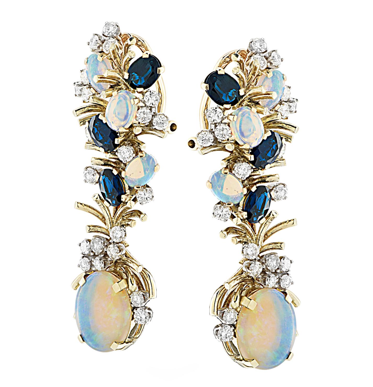 Spectacular dangle earrings crafted in yellow gold, showcasing 8 oval opals weighing approximately 3.5 carats total, 6 oval cut sapphires weighing approximately 1.5 carats total and 42 round brilliant cut diamonds weighing 2 carats total, G-H color,