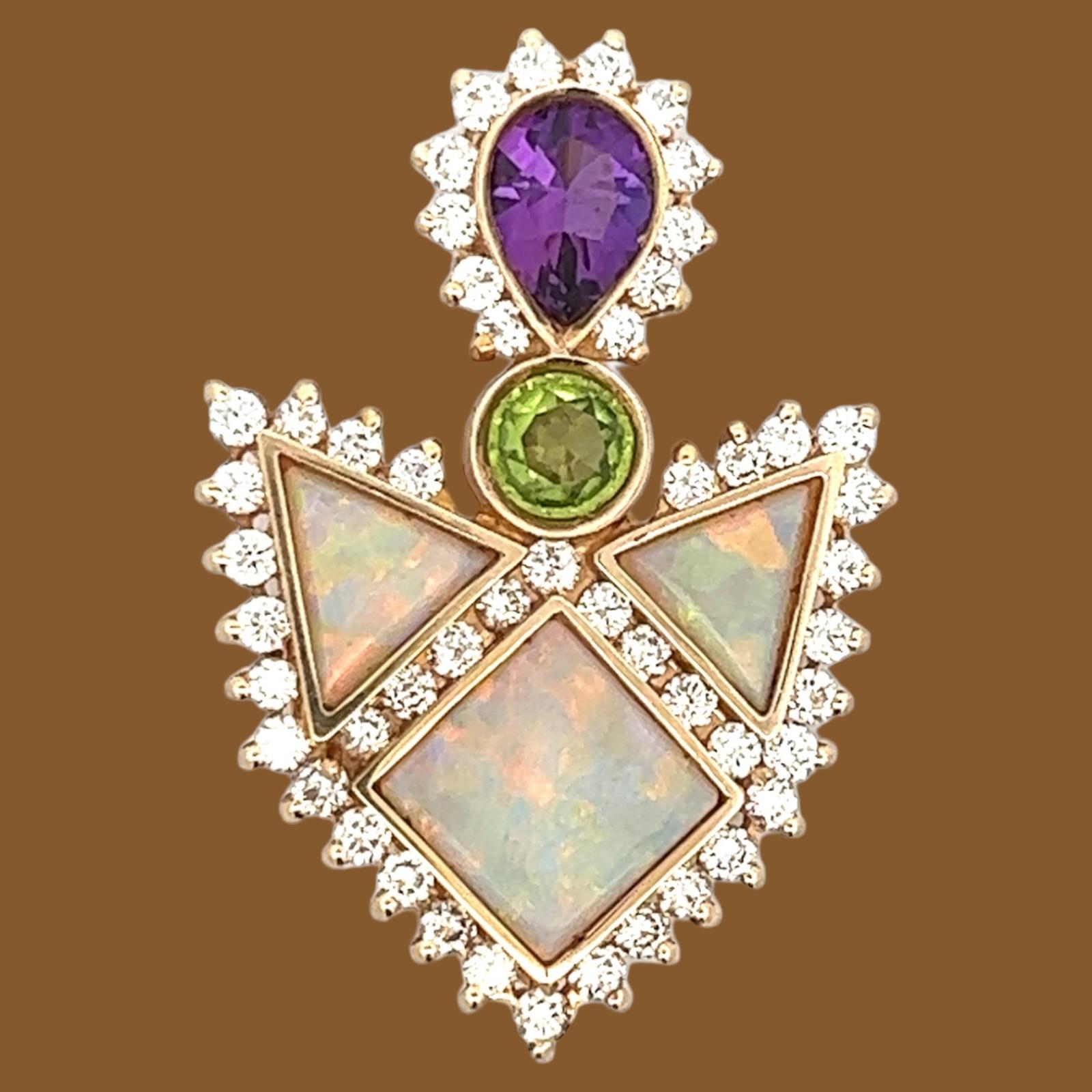 Vibrant diamond and gemstone brooch handcrafted in 14 karat yellow gold. The pin features inlays of opal gemstone, green tourmaline, amethyst, and round brilliant cut diamonds. The diamonds weigh approximately 2.50 carat total weight and are graded