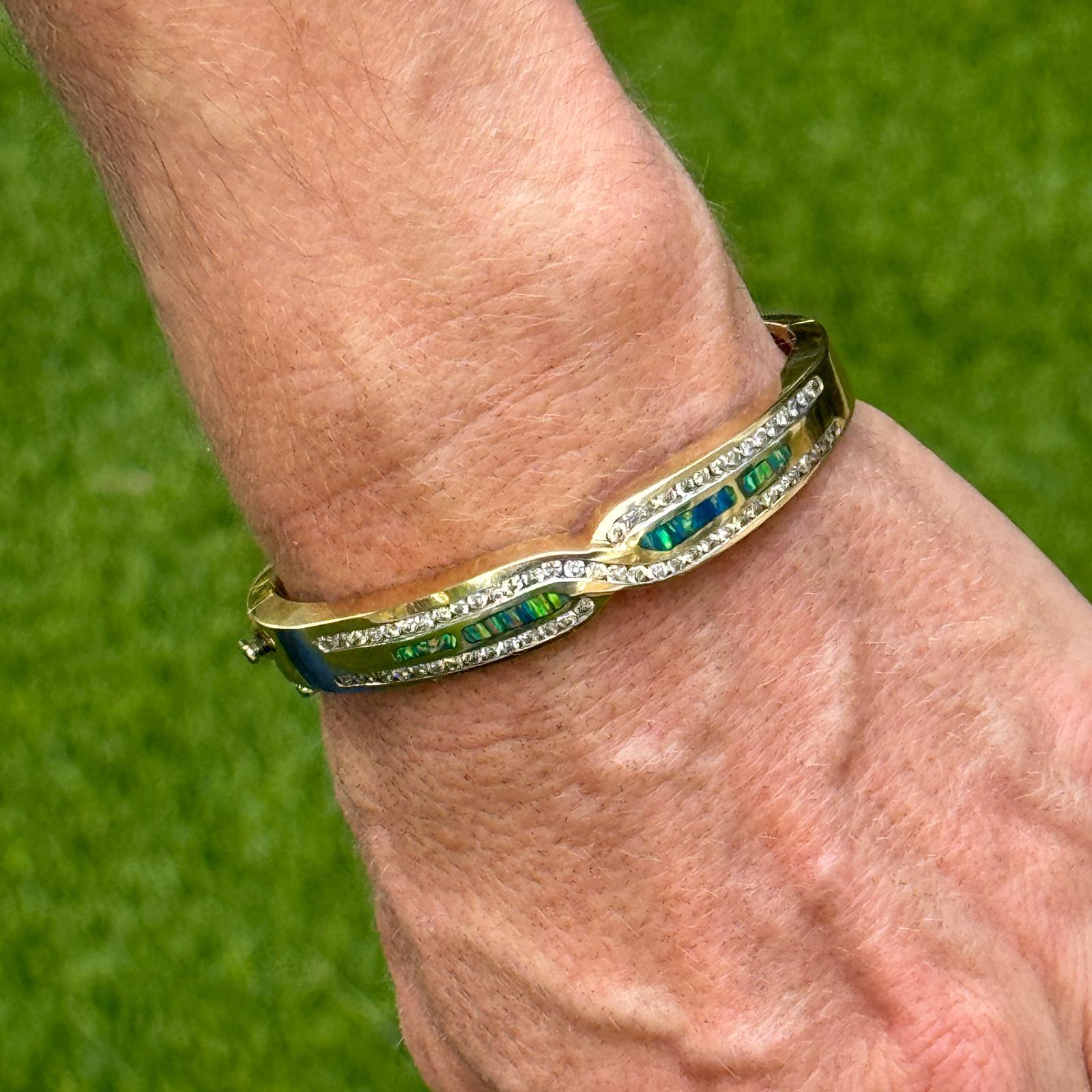 Bracelet moderne en diamant et opale en or jaune 14 carats. Le bracelet présente une incrustation de pierres précieuses opales colorées et des diamants ronds de taille brillant d'un poids total d'environ 1,75 carat. Les diamants sont de couleur I-J