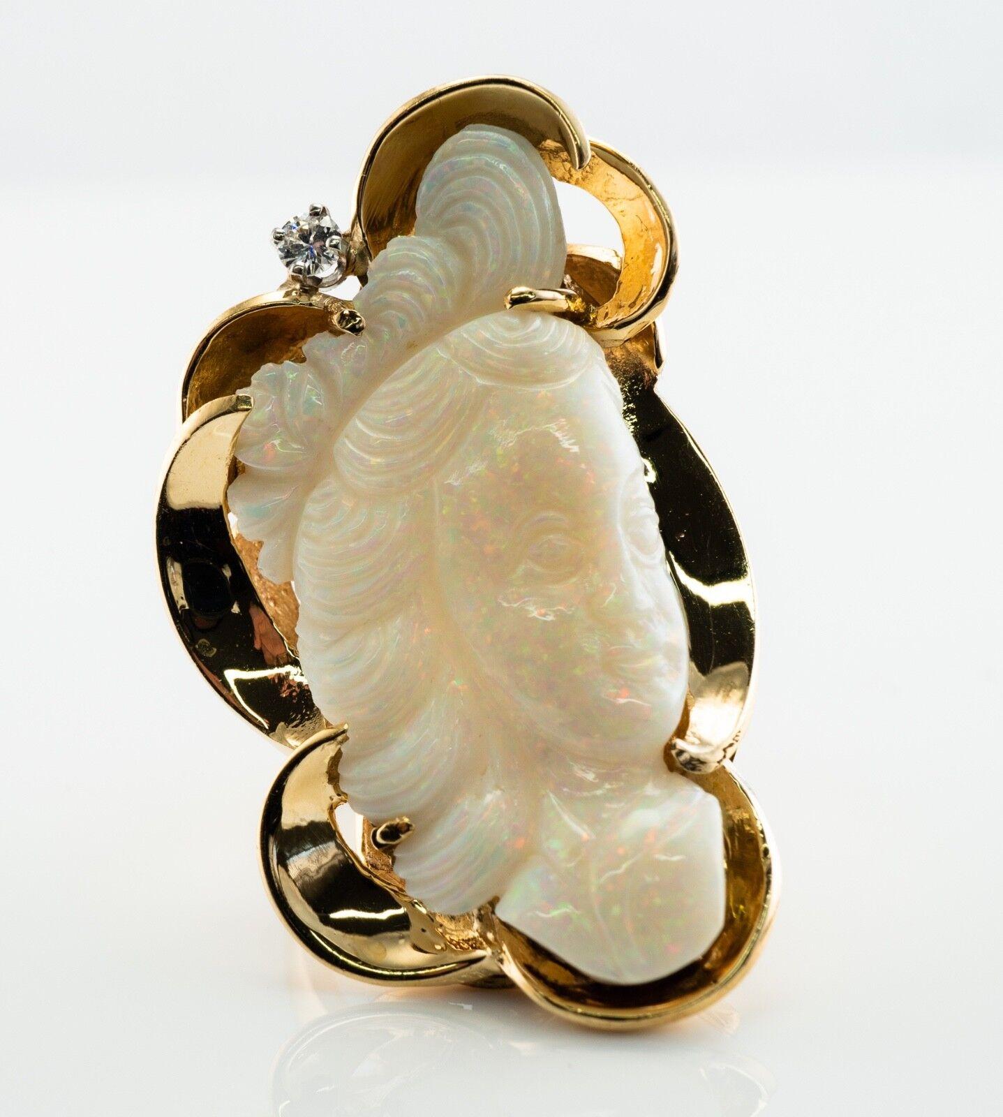 This gorgeous vintage ring is finely crafted in solid 14K Yellow Gold and set with natural carved Opal cameo and diamond. The lovely crystal Opal profile measures 1.5