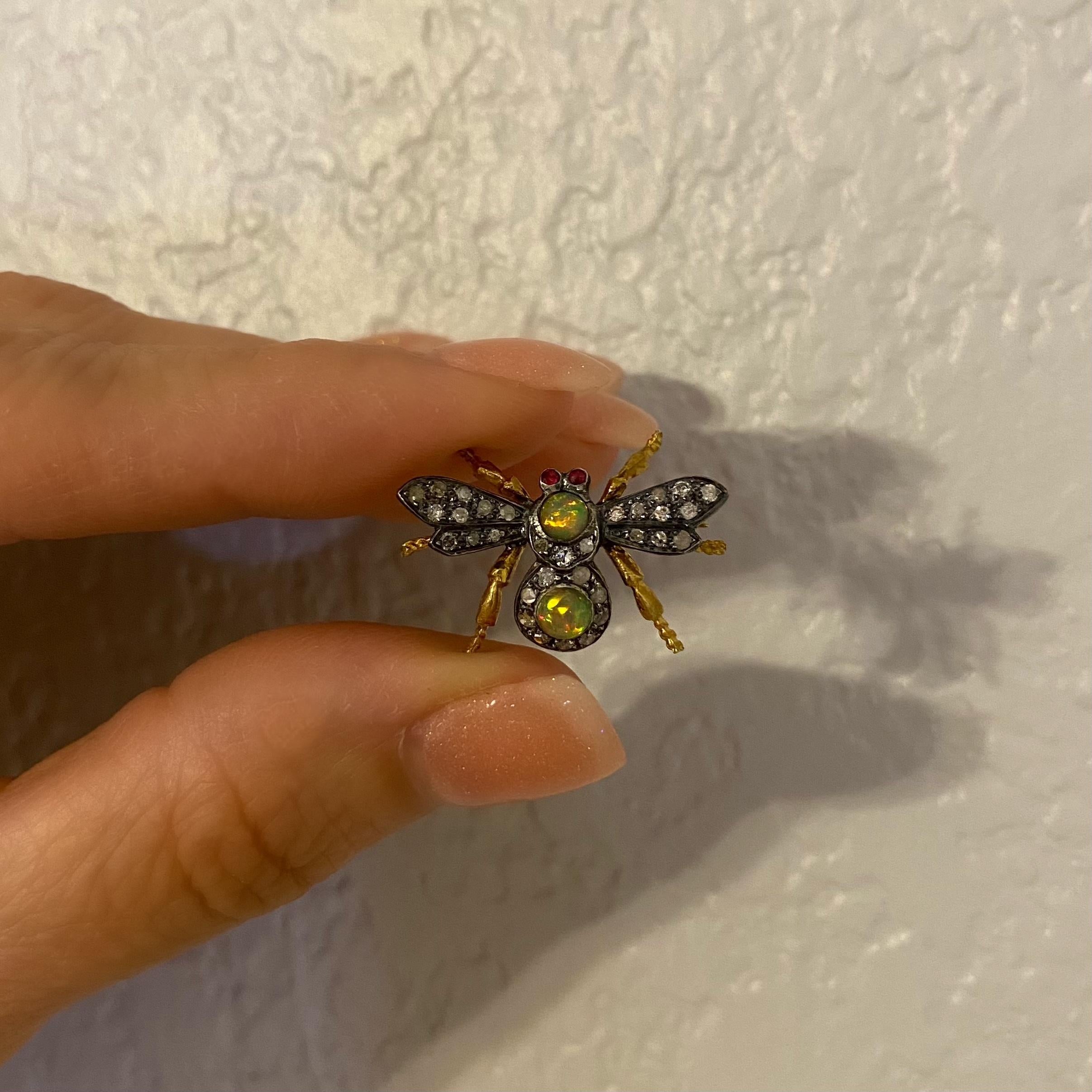 Beautiful Finely detailed Bee Fly Wasp Brooch. Hand set with 32 round Brilliant cut Diamonds, approx. 0.30tcw; 2 round Opals, approx. 0.25tcw and 2 ruby eyes, approx. 0.03tcw. Approx. size: 1 inch tall. Hand crafted in 18 Karat Yellow Gold and