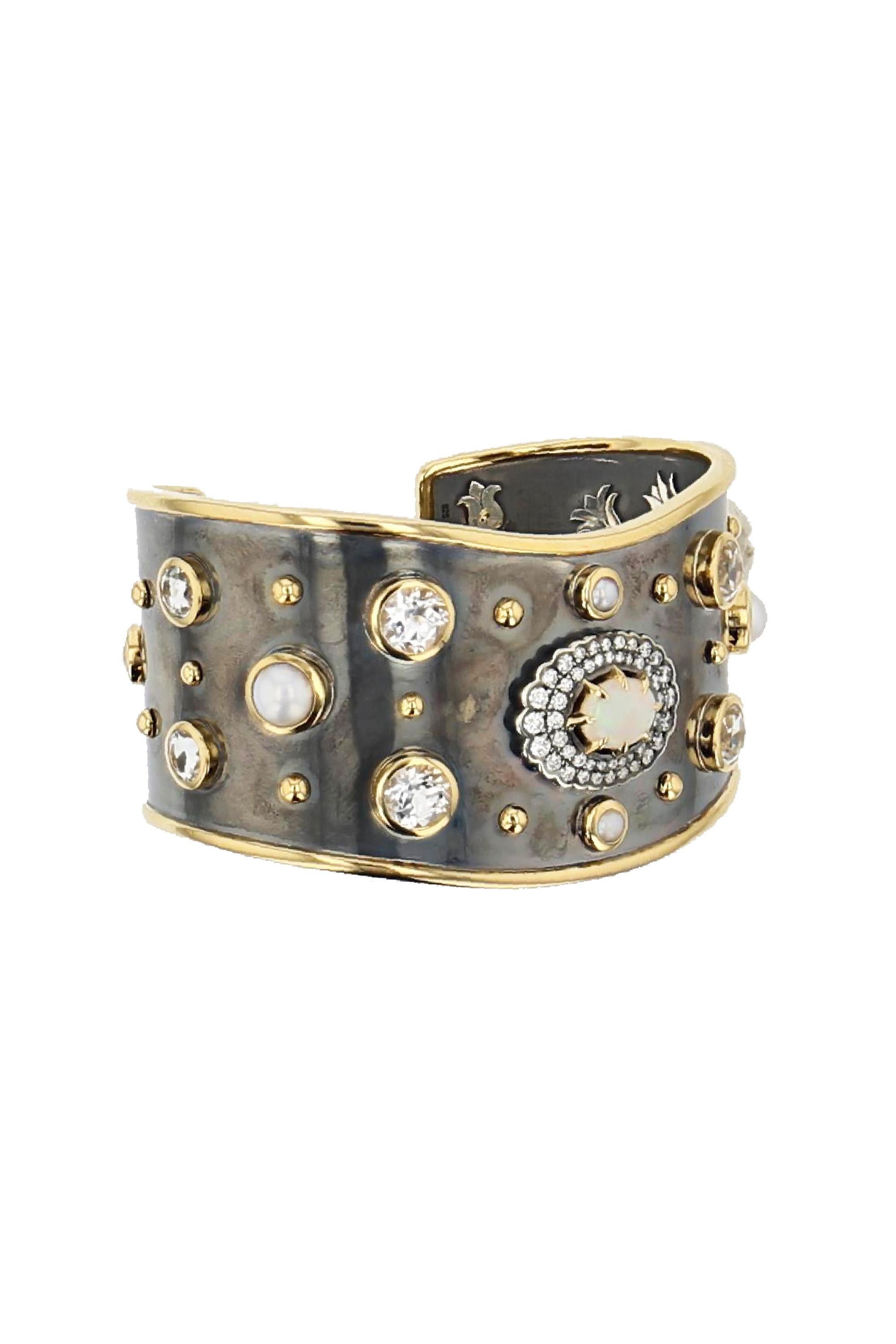 Yellow gold and distressed silver cuff, studded with an opal surrounded by diamonds, akoya pearls and white sapphires.

Details:
Opal, White  Sapphire and Akoya Pearls
Diamond Paving: 0.55 cts
White Sapphire: 4 cts
18k Yellow Gold: 24 g 
Distressed