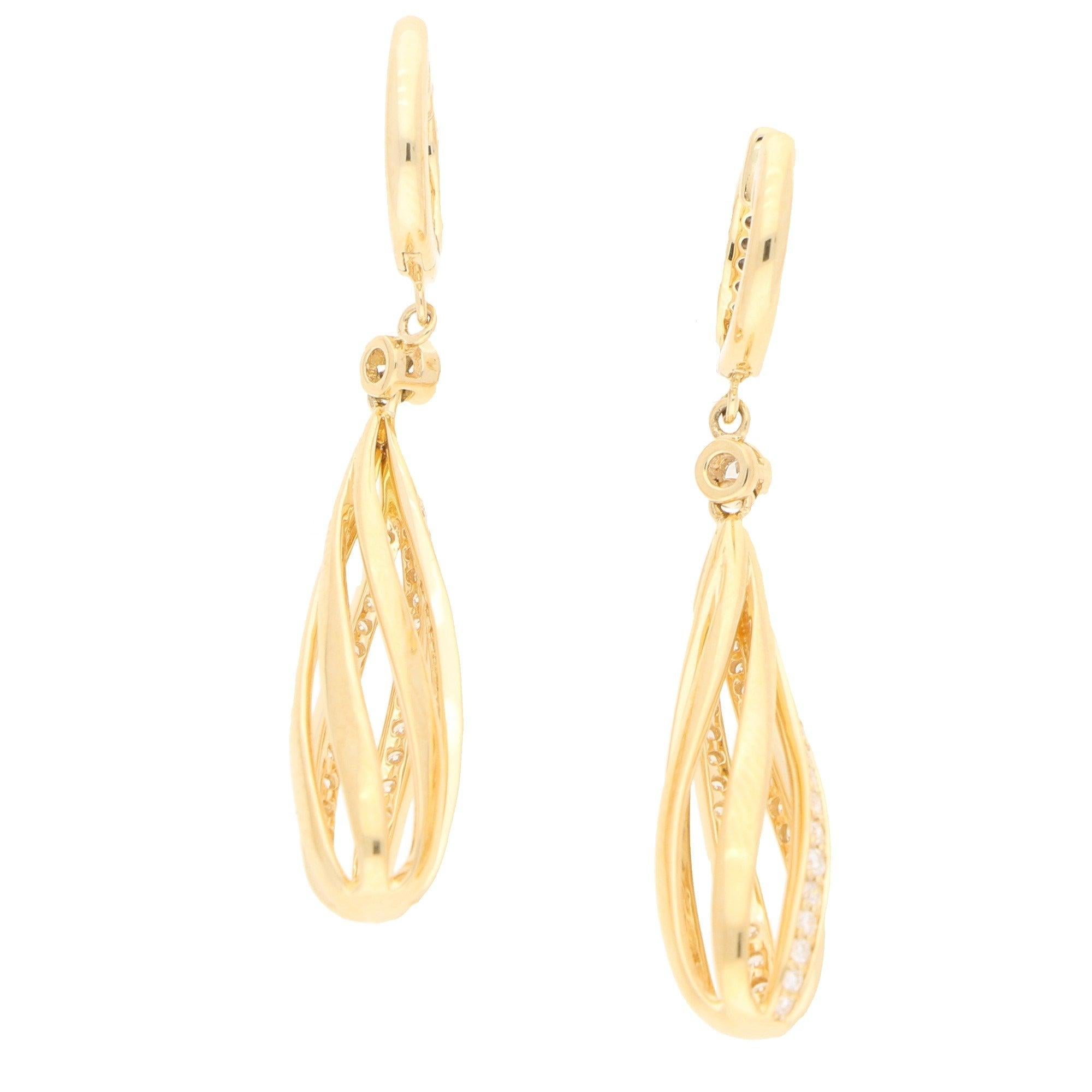 Diamonds approximately 0.60 carats in total, G/H colour, VS clarity.
A pair of diamond spiral earrings in 18-karat yellow gold. 
Each earring is composed of a pear-shaped openwork spiral drop with three of the six spirals grain-set throughout with