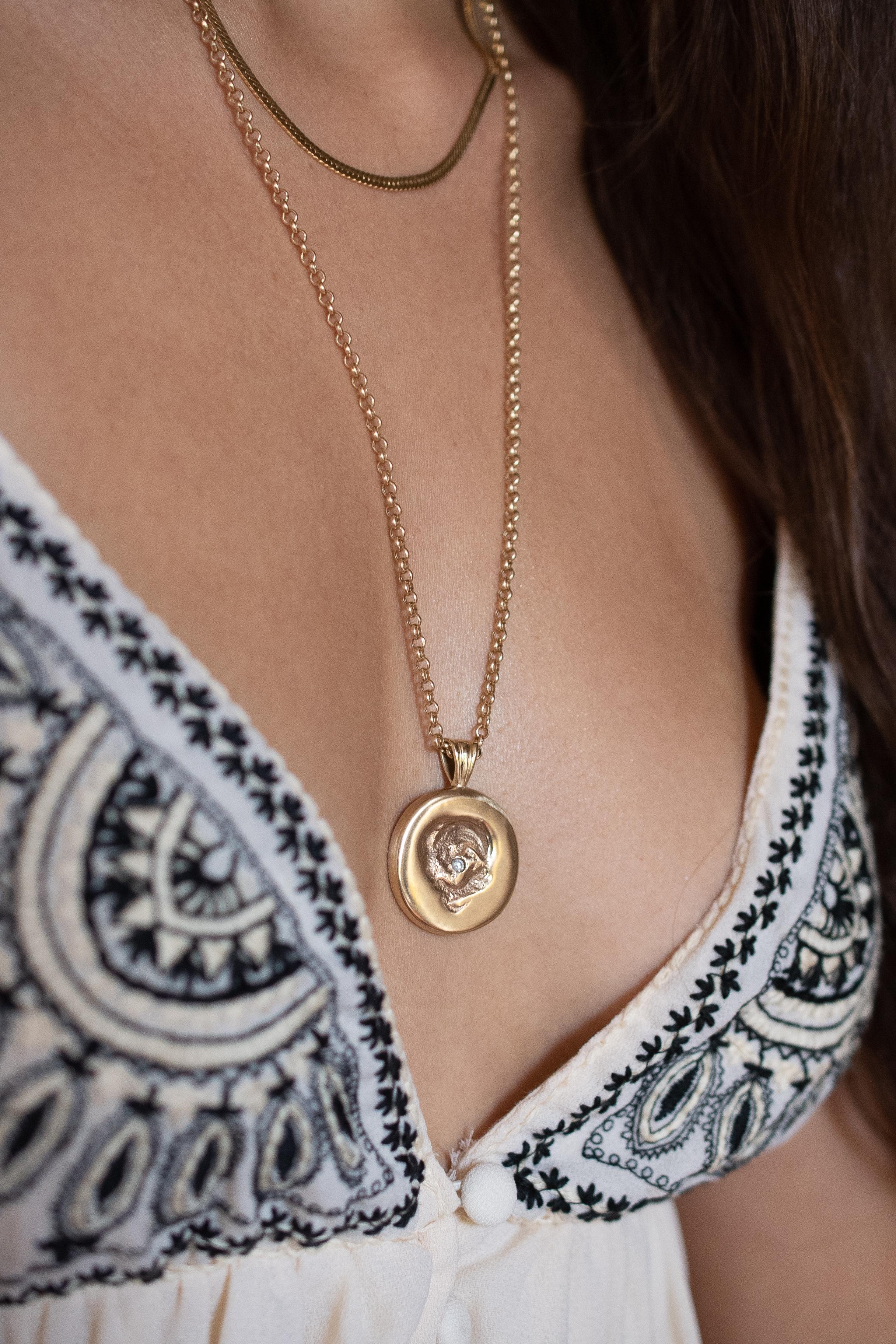 The Diamond Ostrea Necklace is handcrafted from 10K gold and diamonds in Brooklyn, New York by Latasha Lamar. This chain and pendant style necklace includes a rose-cut diamond.

Designed and created in New York by Latasha