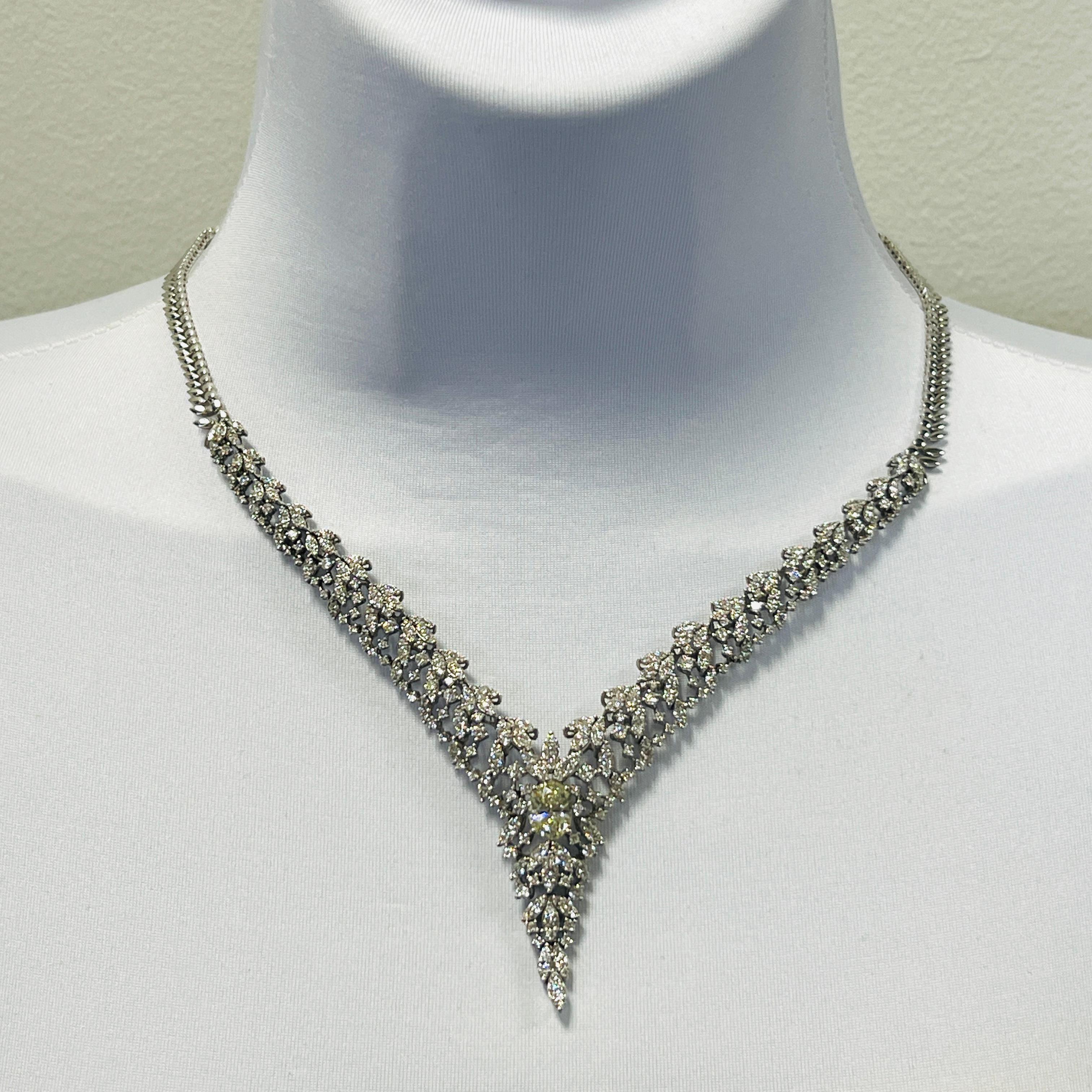 Gorgeous necklace featuring a 2.01 ct. oval center and smaller round diamonds.  Handmade in 14k white gold.  Length is 16