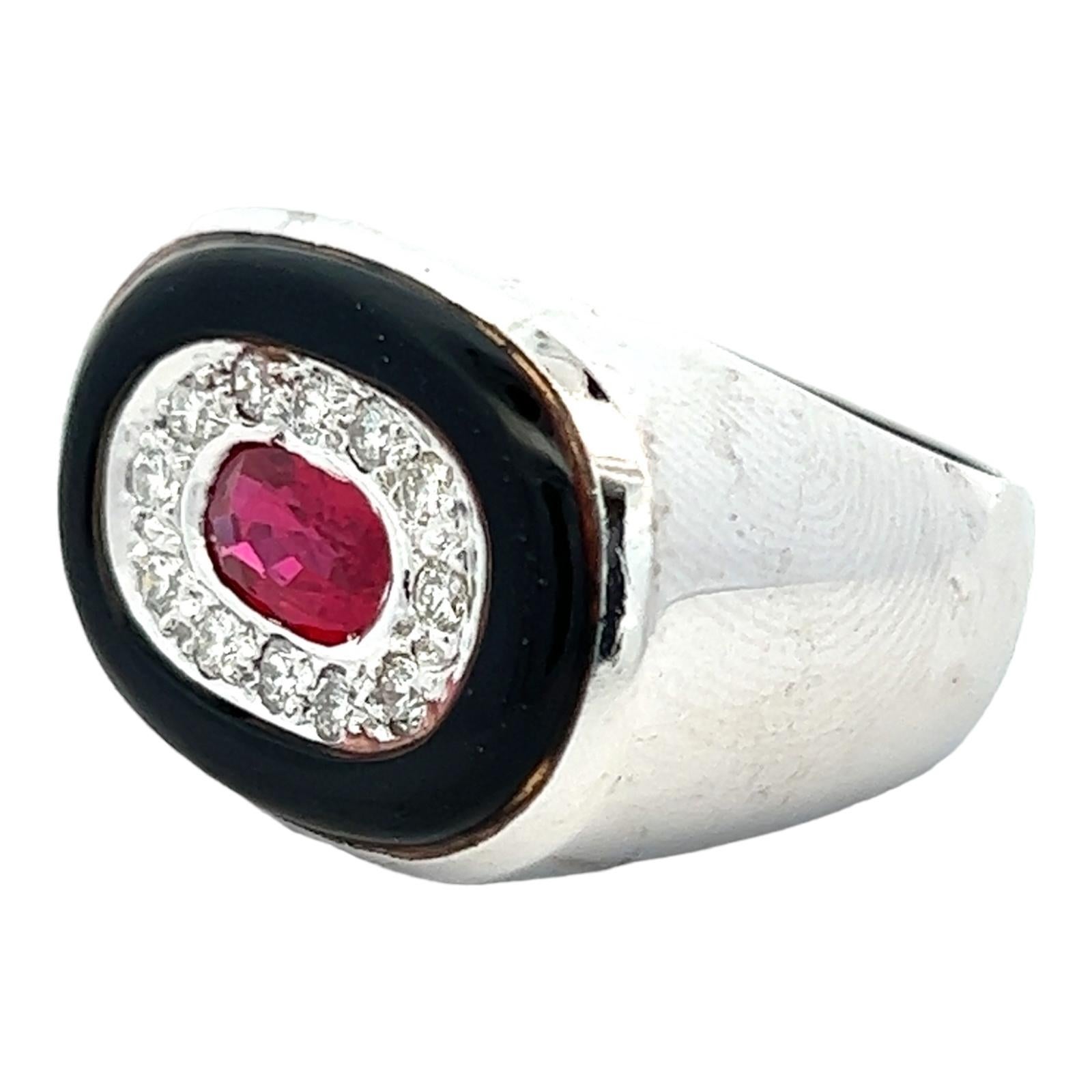 Beautiful diamond, ruby, and onyx cocktail ring handcrafted in 14 karat white gold. The center oval ruby gemstone weighs approximately 1.20 carat and is surrounded by 12 round briliant cut diamonds weighing approximately .36 CTW and black onyx