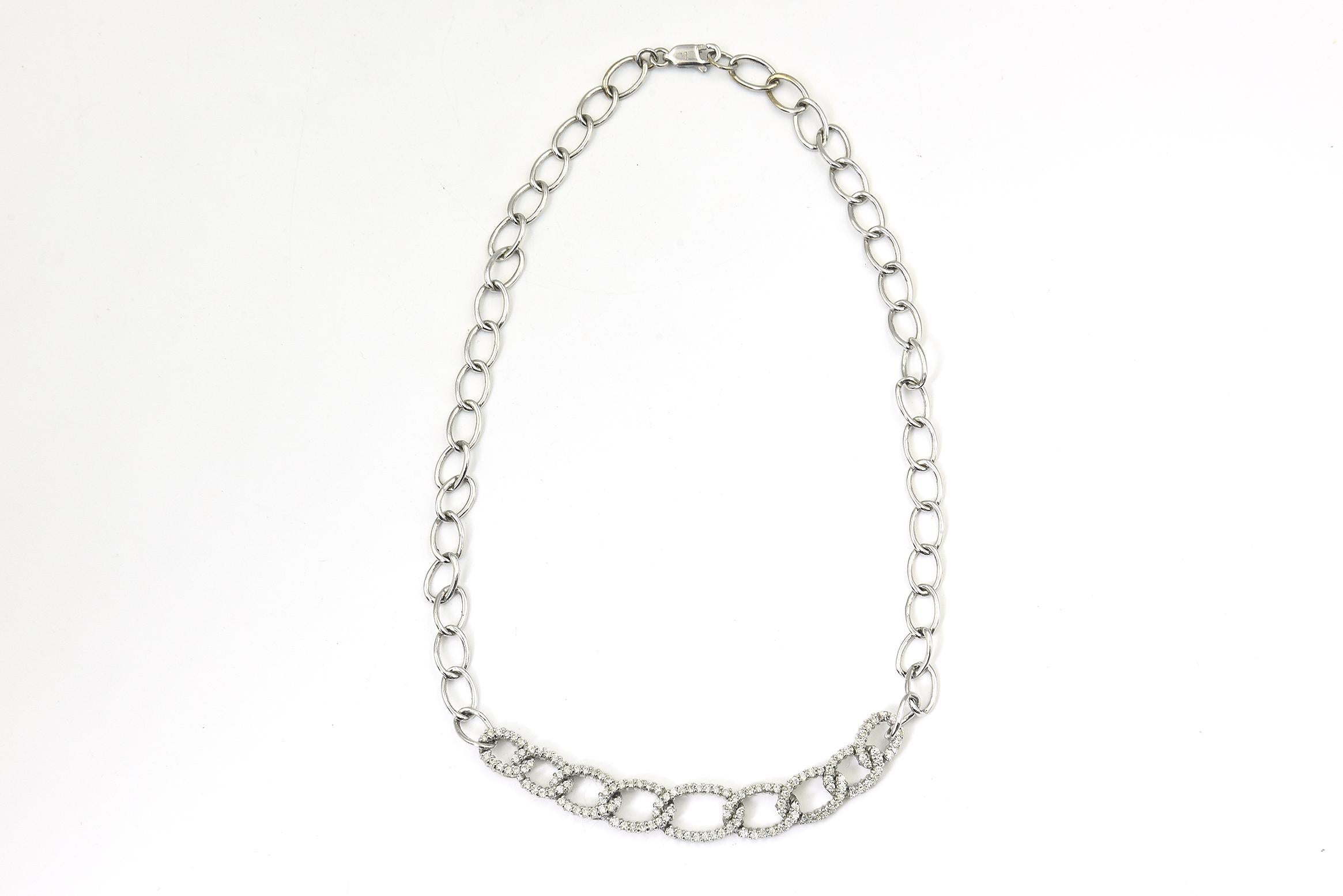 Diamond oval chain link necklace featuring 9 graduated diamond open oval links across the front and the remainder is a simple clean line shiny white gold link.  It is 14 1/4
