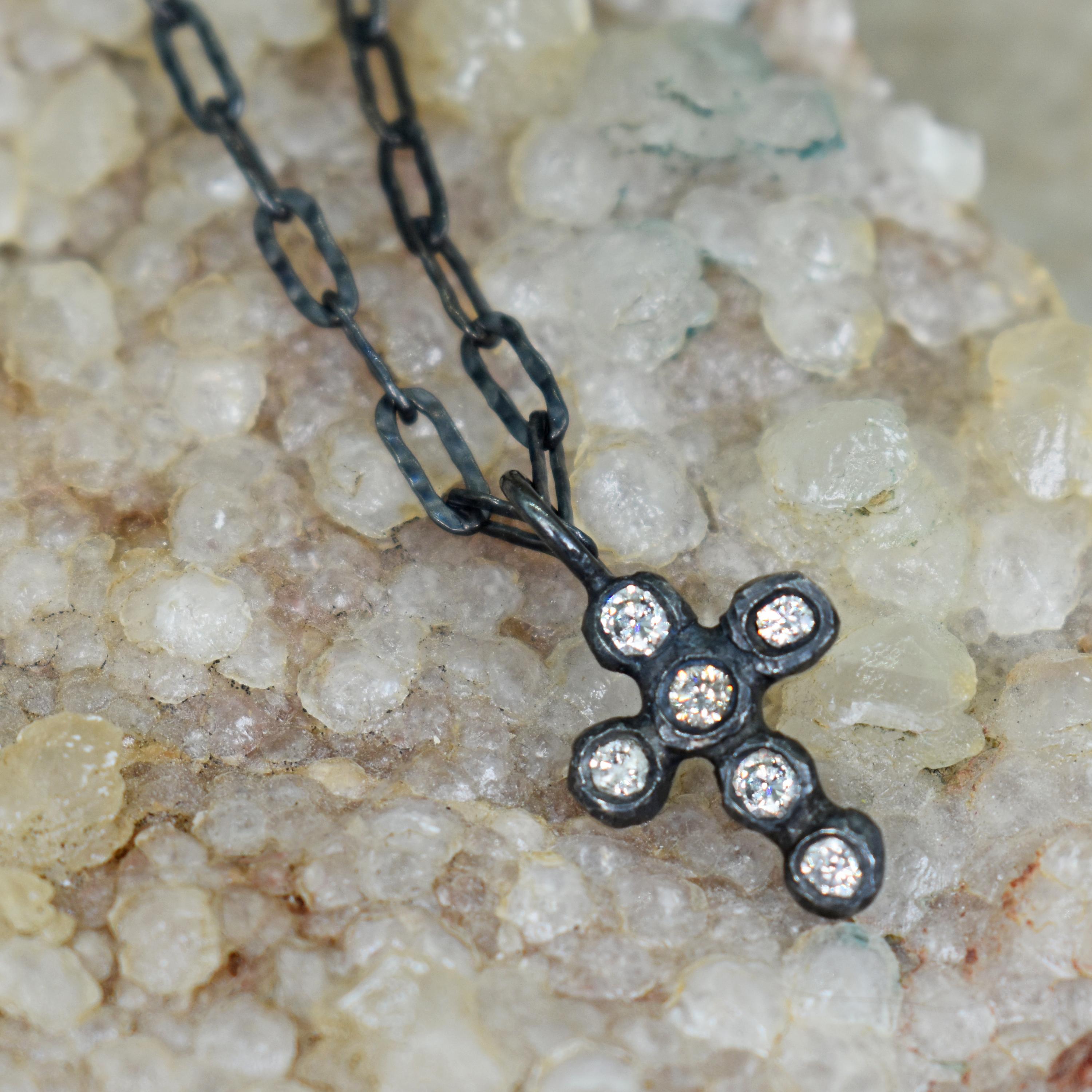 Round white Diamonds (0.24 total carat) set in an oxidized sterling silver cross pendant on a hammered, paperclip / elongated cable chain. Pendant is 0.88 inch in length, and chain is 16 inches in length.