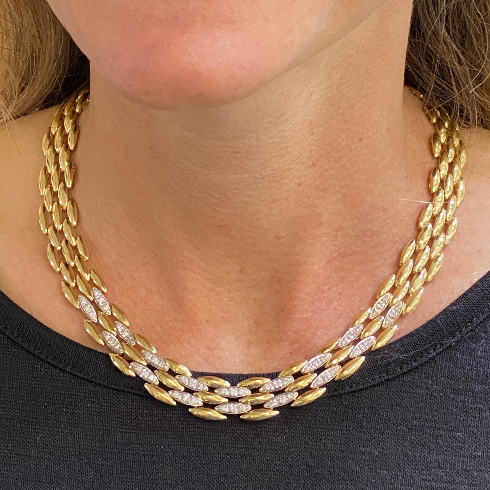 Diamond panther link necklace crafted in 14 karat yellow gold. The necklace features 54 round brilliant cut diamonds weighing approximately 1.00 carat total weight and graded H-I color and SI clarity. The five rows measure .50 inch in width, and the