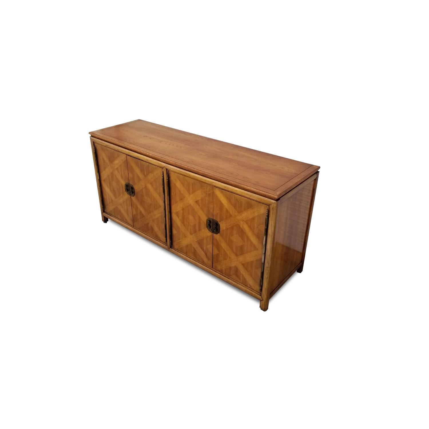 Exceptional styling on this vintage Hollywood Regency buffet. This distinctive sideboard is made of pecan wood. The facade is embellished with a handsome diamond pattern parquet. Bands of pecan wood intersect to create an argyle pattern with a