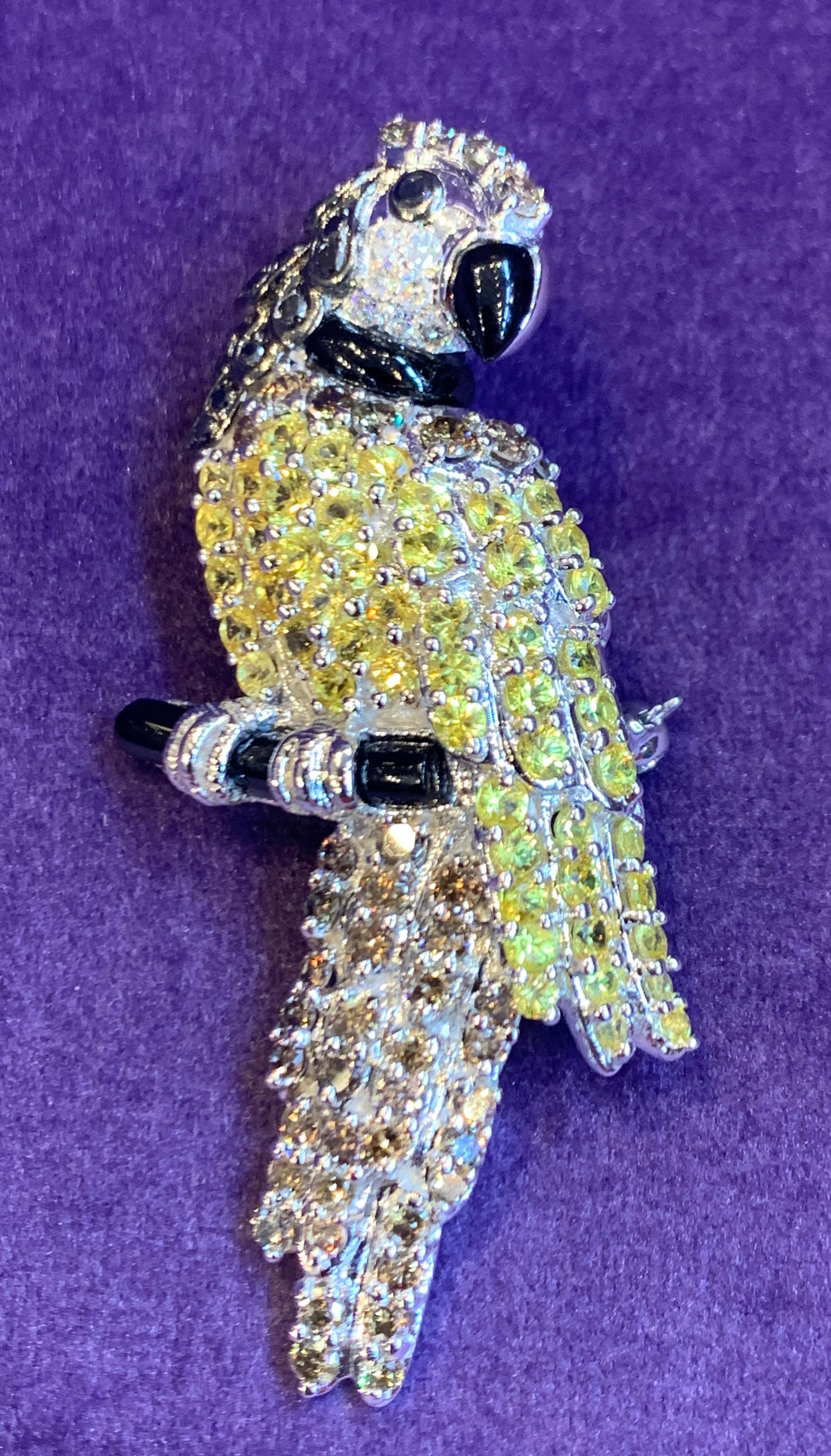 Diamond  & Onyx Parrot Brooch white, black, colored diamonds & yellow sapphire all set in 18K White Gold.
103 diamonds total
Total Diamond Weight: 2.15 Cts 
Measurements: 2 inches long 