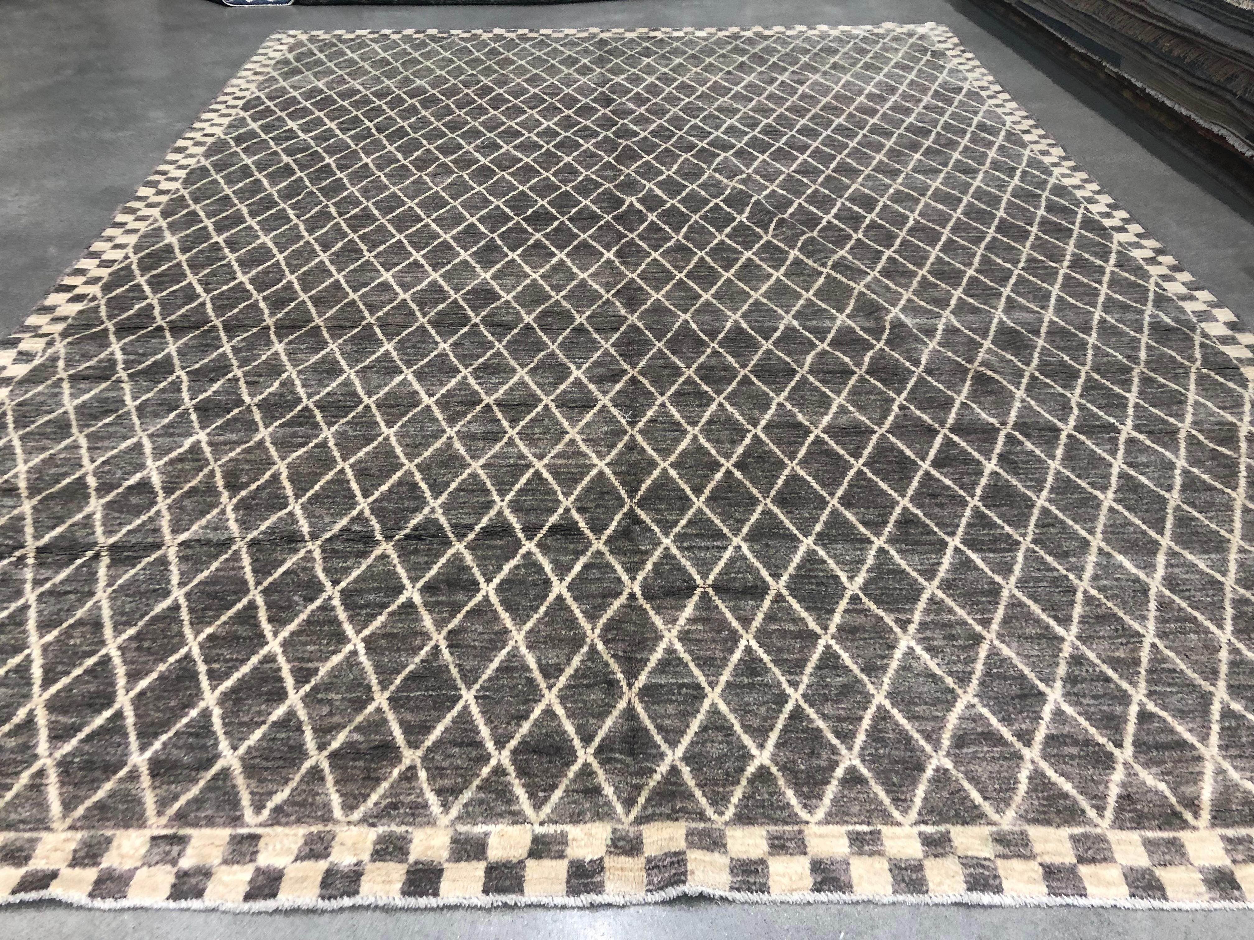 Coming from our newest collection of Modern Moroccan designs, this brown and cream diamond pattern Moroccan design area rug is handmade and hand-knotted made in Pakistan. It has a cotton base and is made from all wool yarns. It features a textured
