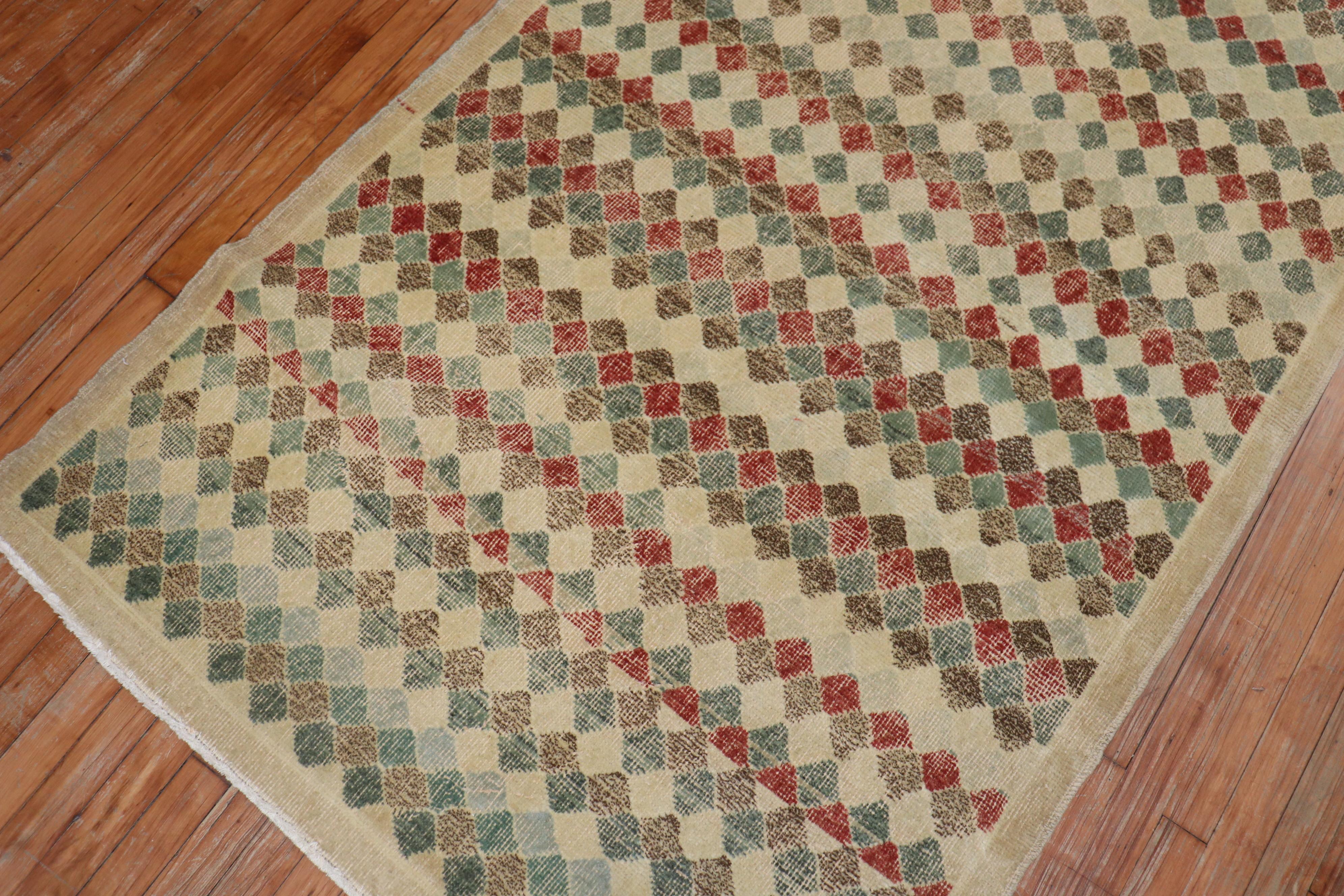 Vintage Turkish Deco rug with an all-over diamond motif on a beige field. Accents in red, brown, green blue and rust.

Measures: 4' x 8'7