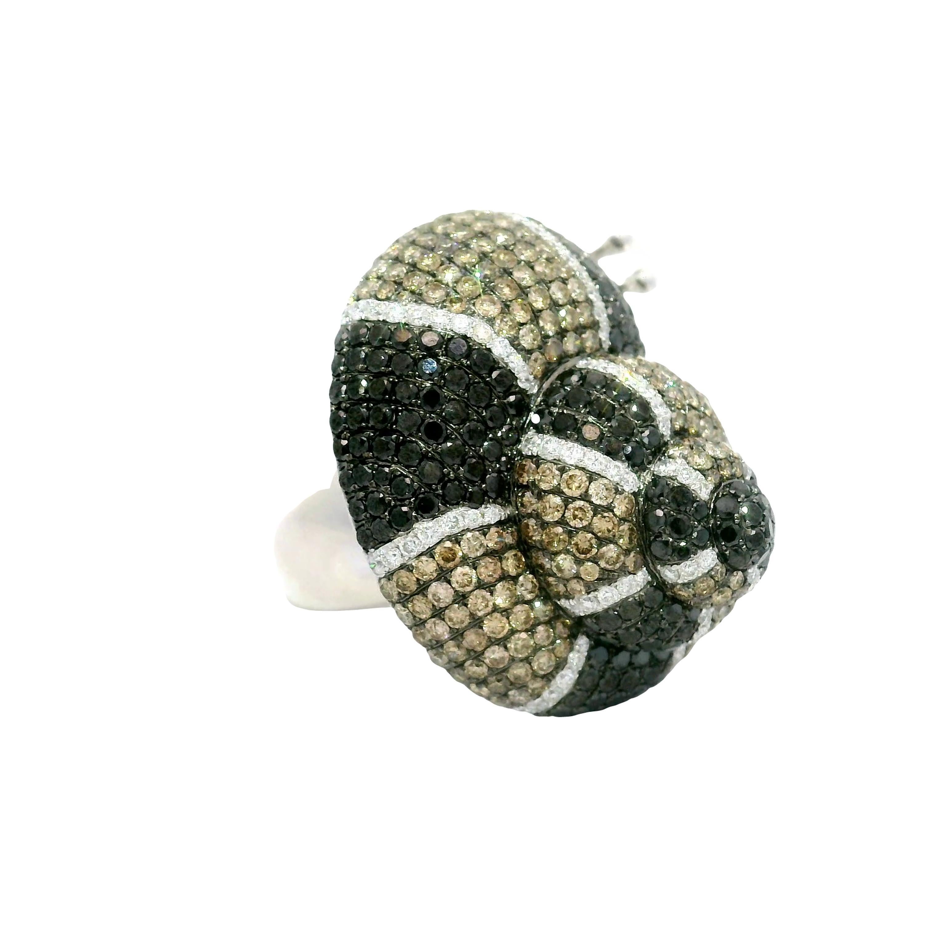 A captivating snail design graces this contemporary animal ring. The snail’s shell is adorned with round brilliant-cut diamonds weighing a total of approximately 5 carats. The range in color from bright white, to fancy cognac and deep black which