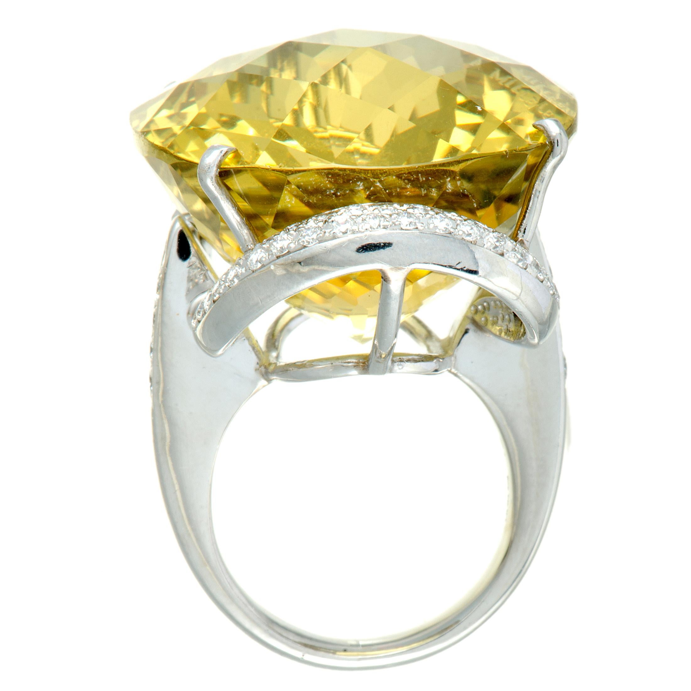 The spectacular lemon citrine takes the central place in this superb platinum ring in an exceptionally imposing fashion, luxuriously accentuated by the irresistibly scintillating diamond stones. The citrine weighs astounding 68.71 carats and the