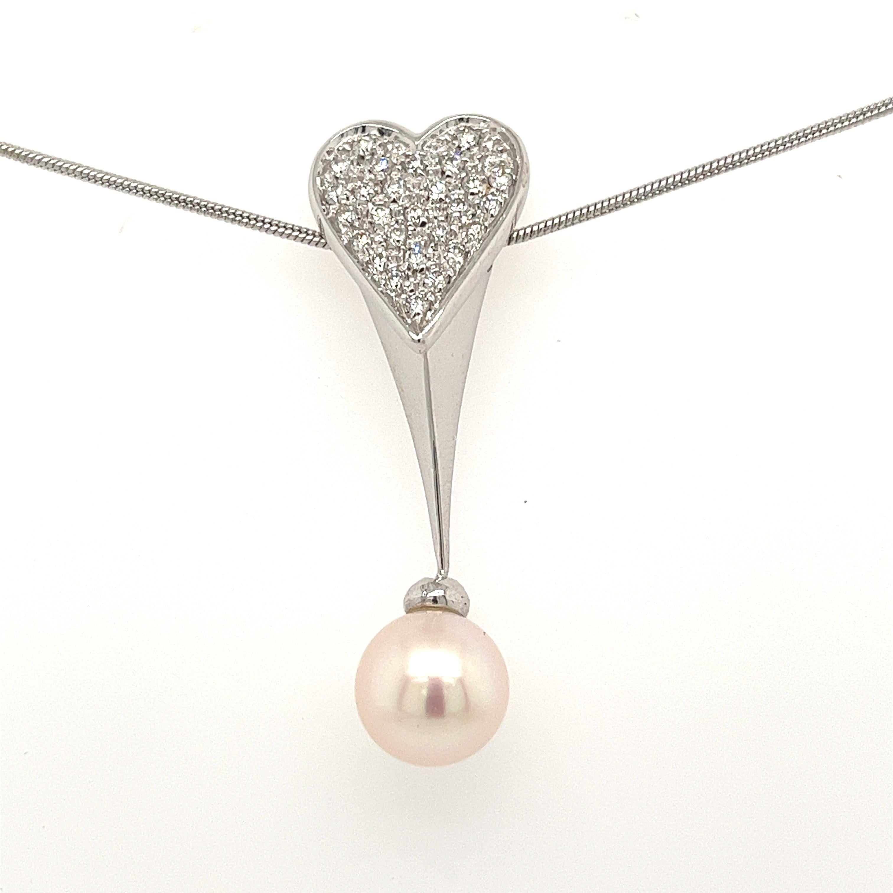 Shop this one of one, natural diamond and pearl drop pendant. Handmade with a themed motif of love and friendship. This drop pendant features 0.70 carats in natural white diamonds and a dainty pink pearl drop. Diamonds are set in an 18k white gold