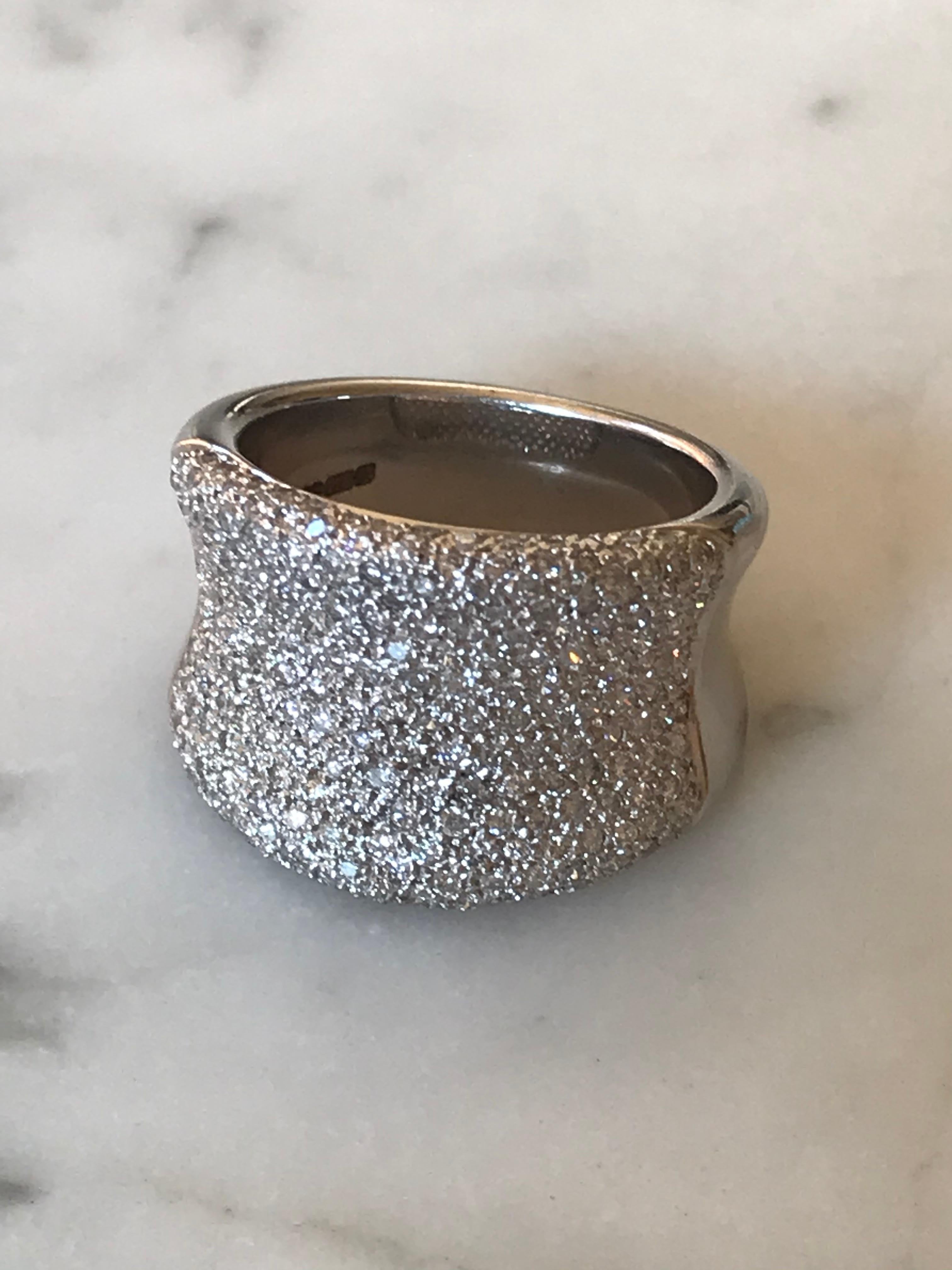Wide Pavé Diamond Bombe Concave Cocktail ring in 18k white gold. Featuring 1.3 carats of brilliant cut diamonds and measuring 1.5cms at the wide point. finger size 7.

Pavé pronounced “pa-vay,” originates from the French word “to pave” — in this