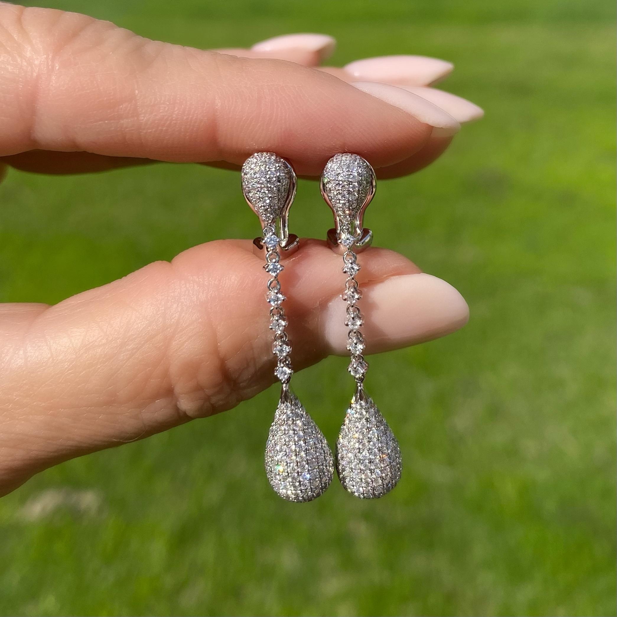 Simply Beautiful and Stylish Pave Diamond White Gold Drop Earrings. Each Dangle Earring Hand set with Diamonds weighing approx. 1.80 Carat total weight. Each earring measuring approx. 1.75” l x