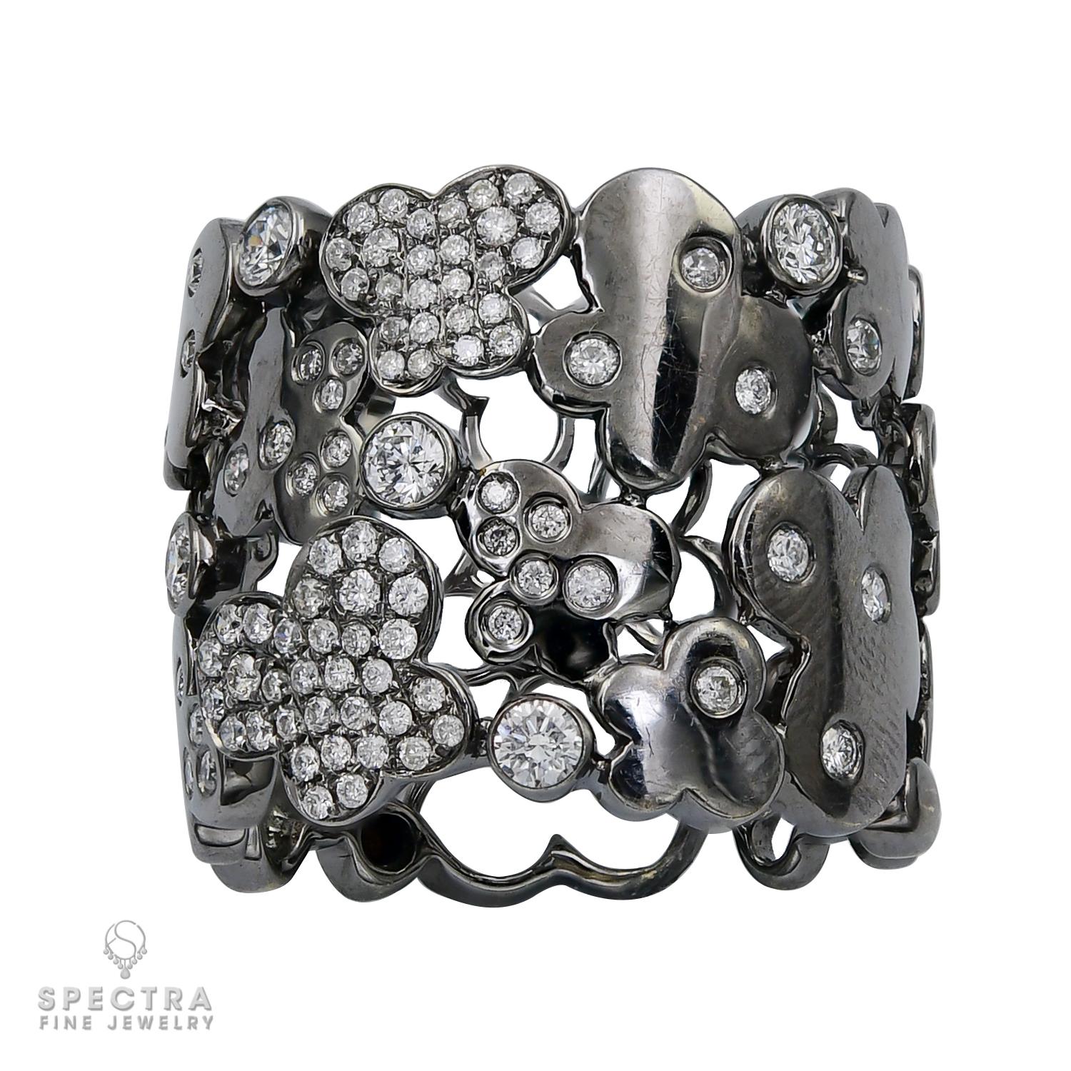 This Contemporary Diamond Pavé Filigree Wide Band Ring exudes airy elegance with its openwork lattice design, allowing light to enhance its sparkle. Crafted in rhodium-plated 18K white gold, it features floating abstract motifs—clouds, flowers,