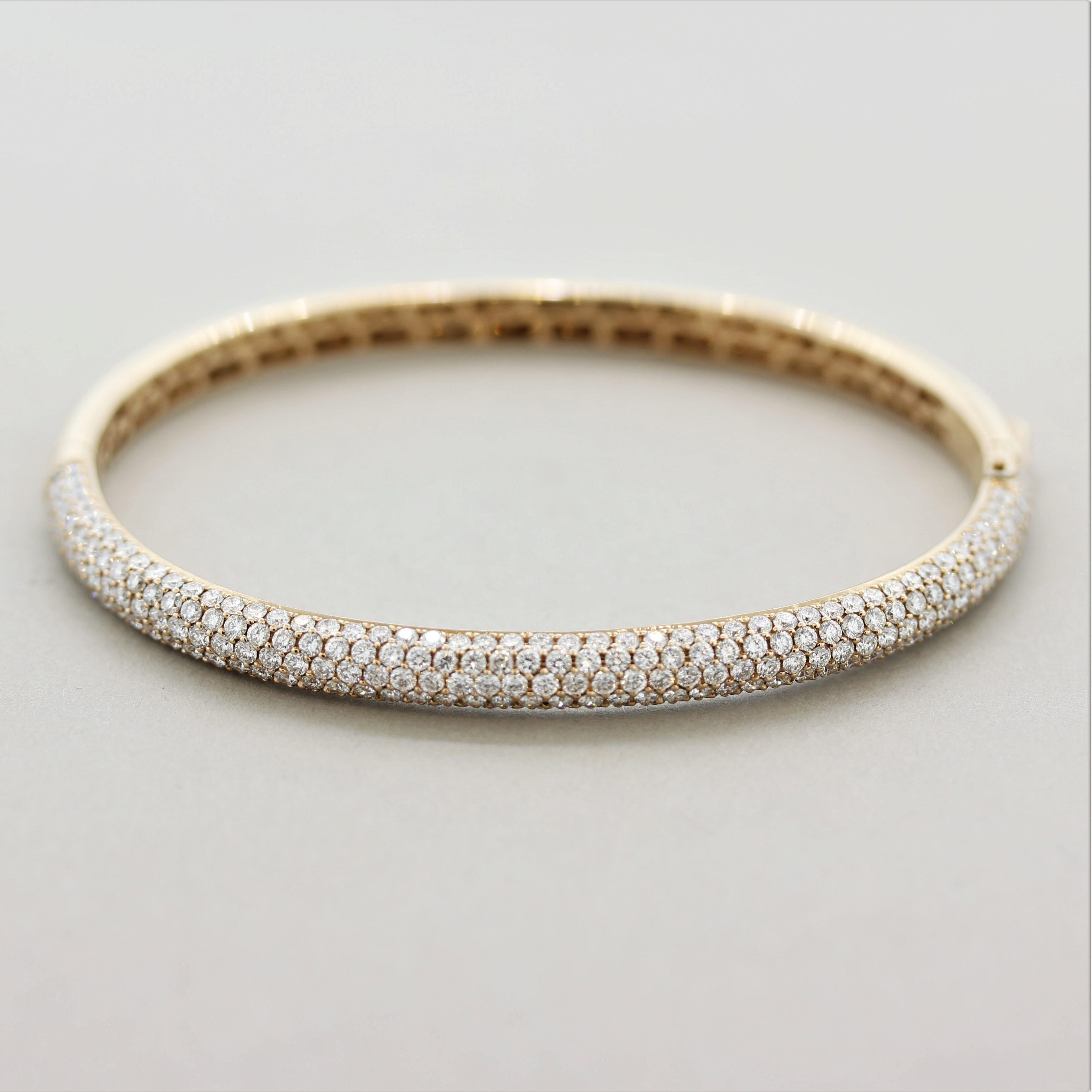 A stylish bangle bracelet featuring 4.43 carats of extra fine round brilliant-cut diamonds. Their quality can easily be noticed by the amount of brilliance and sparkle coming from them. They are pave-set in perfect spacing from each other blanketing