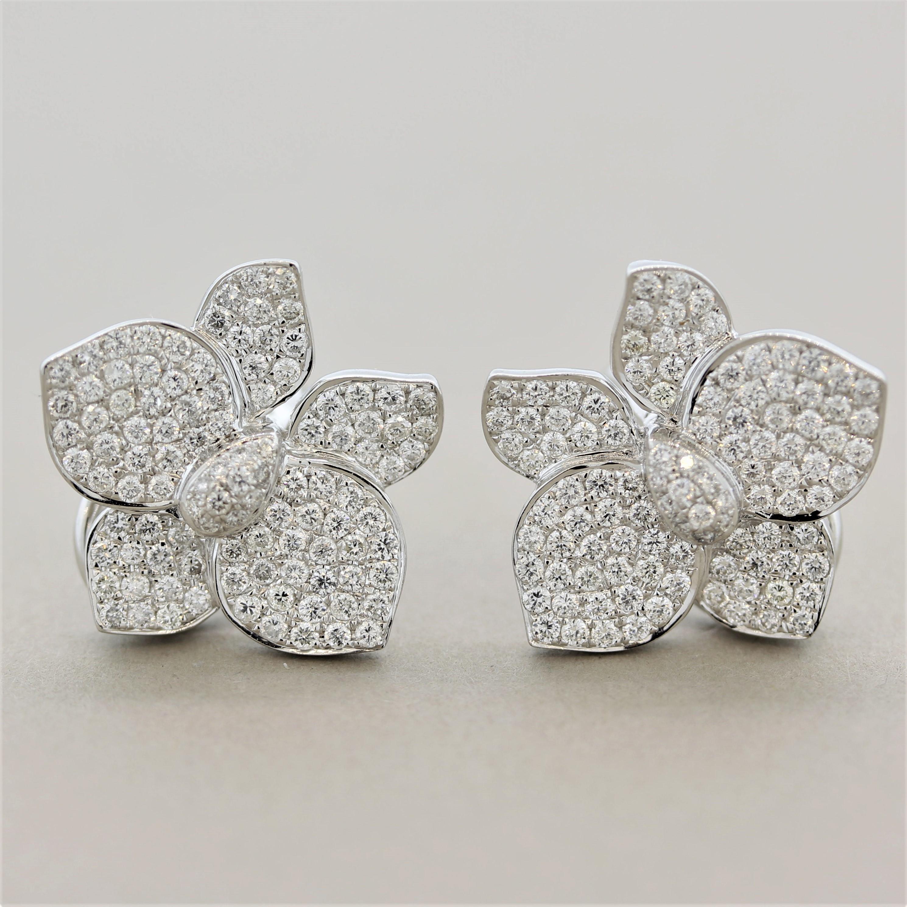 A sweet pair of earrings featuring 1.71 carats of fine round brilliant-cut diamonds full of like and sparkle. They are pave-set and completely cover the earrings designed as a flower in full blossom. Made in 18k white gold and ready to be worn and