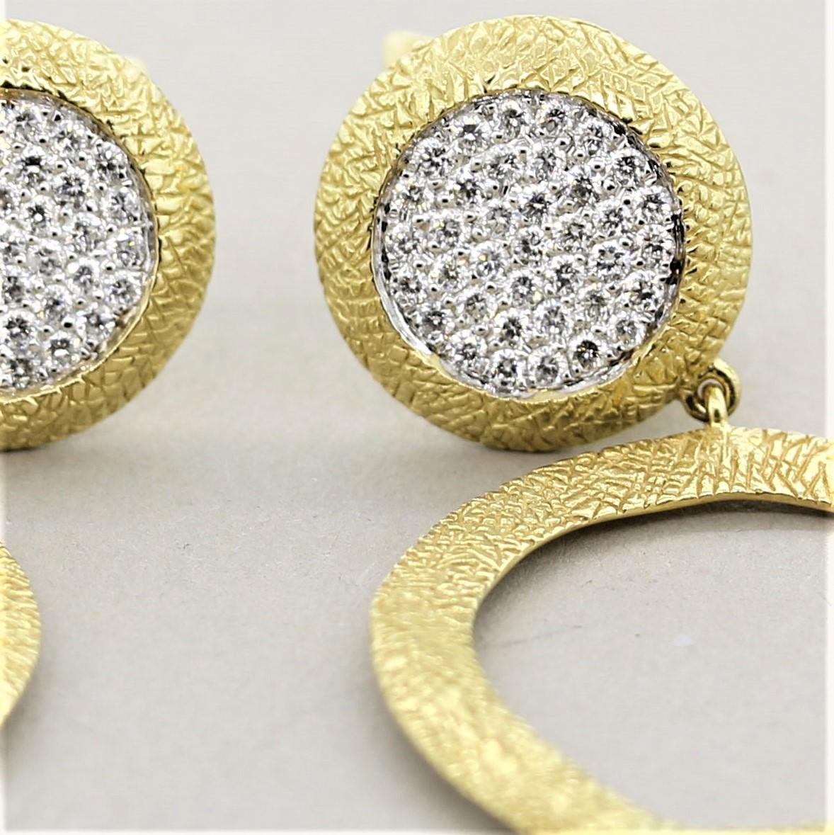A lovely pair of hand-sculpted gold earrings which feature 0.70 carats of bright white pave set round brilliant cut diamonds. Below the diamonds is a gold hoop drop which is hand sculpted giving the gold a unique design and texture which is also