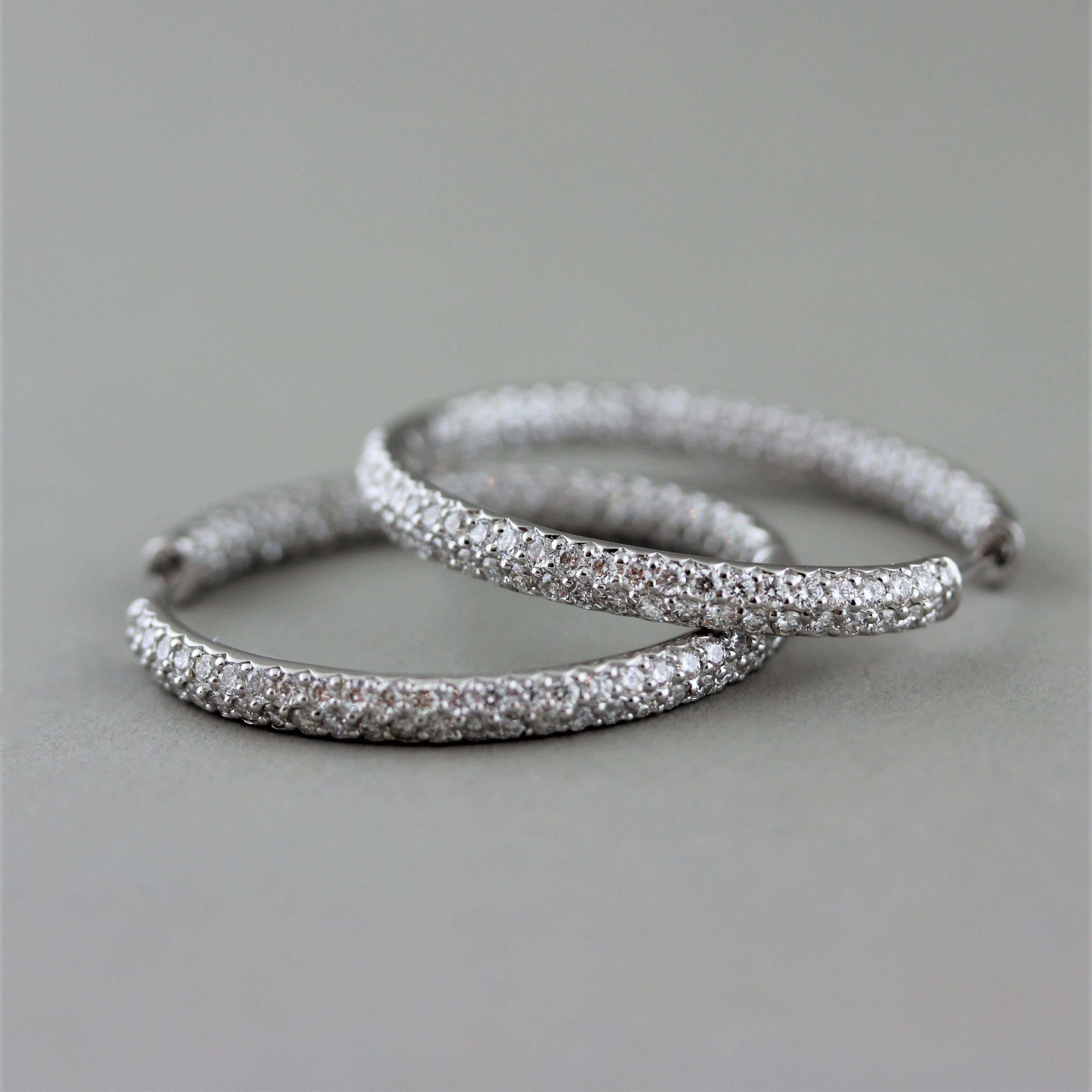 A modern take on the classic hoop earrings! These hoops feature 1.96 carats of round brilliant cut diamonds pavé set in 18k white gold. Earrings that can be worn everyday and dressed up for a night out. 


Length: 1.1 inches


Weight: 7.1 grams
