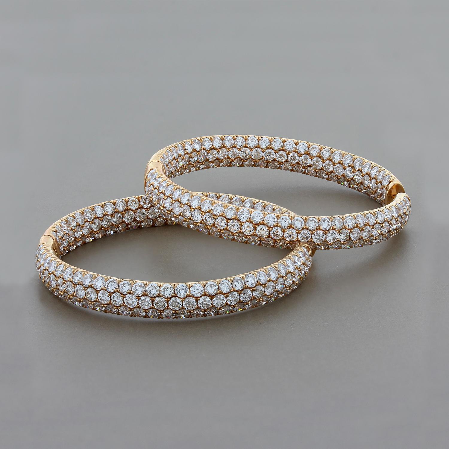 This pair of elegant and sophisticated hoop earrings feature 9.50 carats of round cut VS quality pave set diamonds. The diamonds are top quality white diamonds and shine from every angle.  As an added bonus the diamonds are set inside the hoops for
