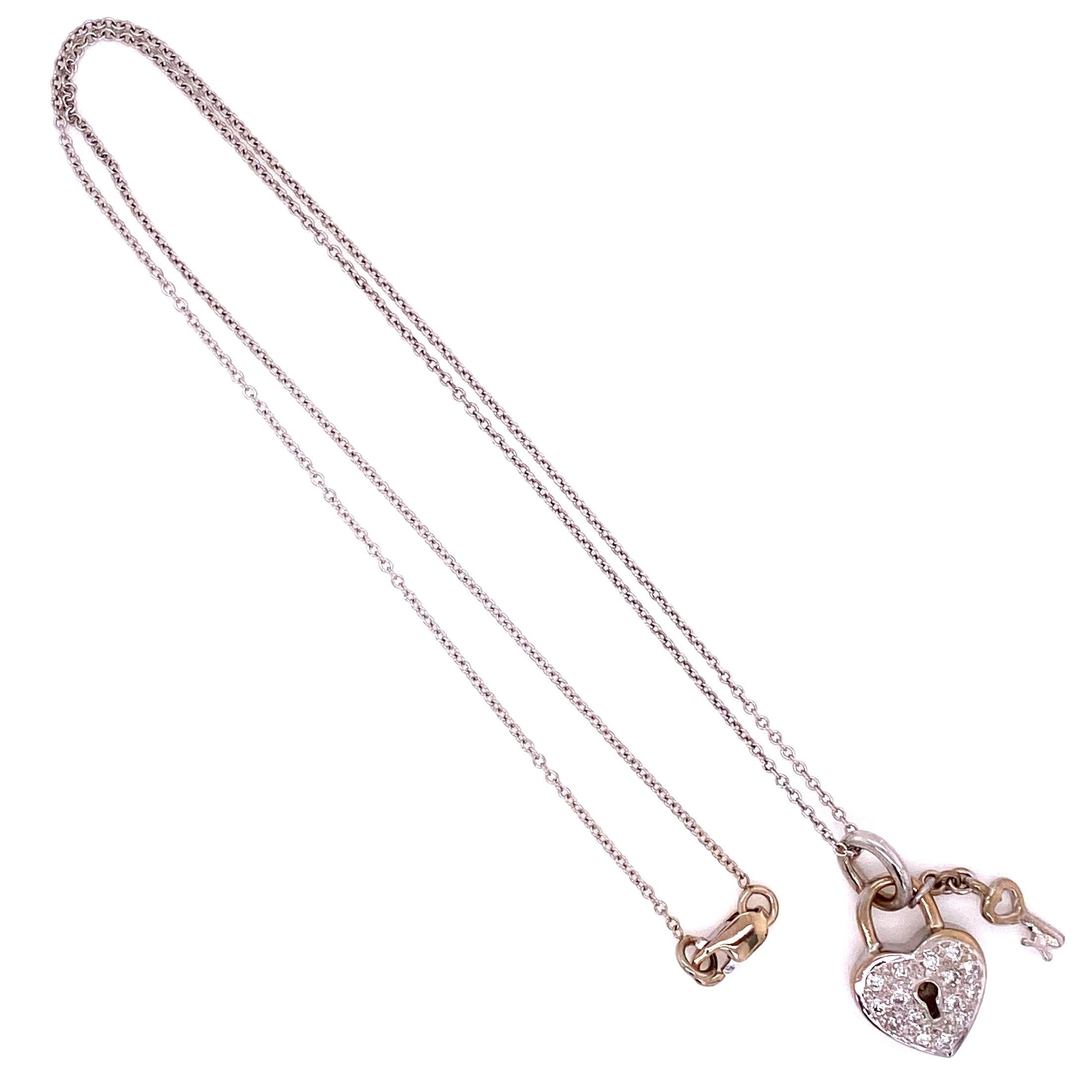 Beautiful and Finely Detailed Pave Diamond Heart Lock and dangling Key Pendant, set with round brilliant cut Diamonds, weighing approx. 0.22 Carat total weight. Hand crafted in 18 Karat white Gold. Chain measures approx. 16 inches. This pendant