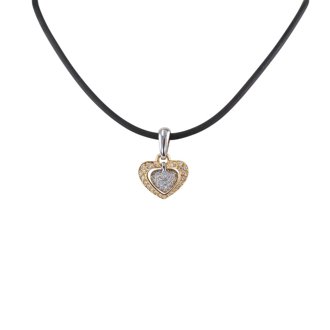 Diamond pavé gold heart-shaped pendant circa 1990.

DETAILS:
Diamond and gold articulated heart-shaped pendant.
DIAMONDS: fifty-eight round brilliant-cut diamonds totaling approximately 1.00 carat, approximately H – I color and SI clarity.
METAL: