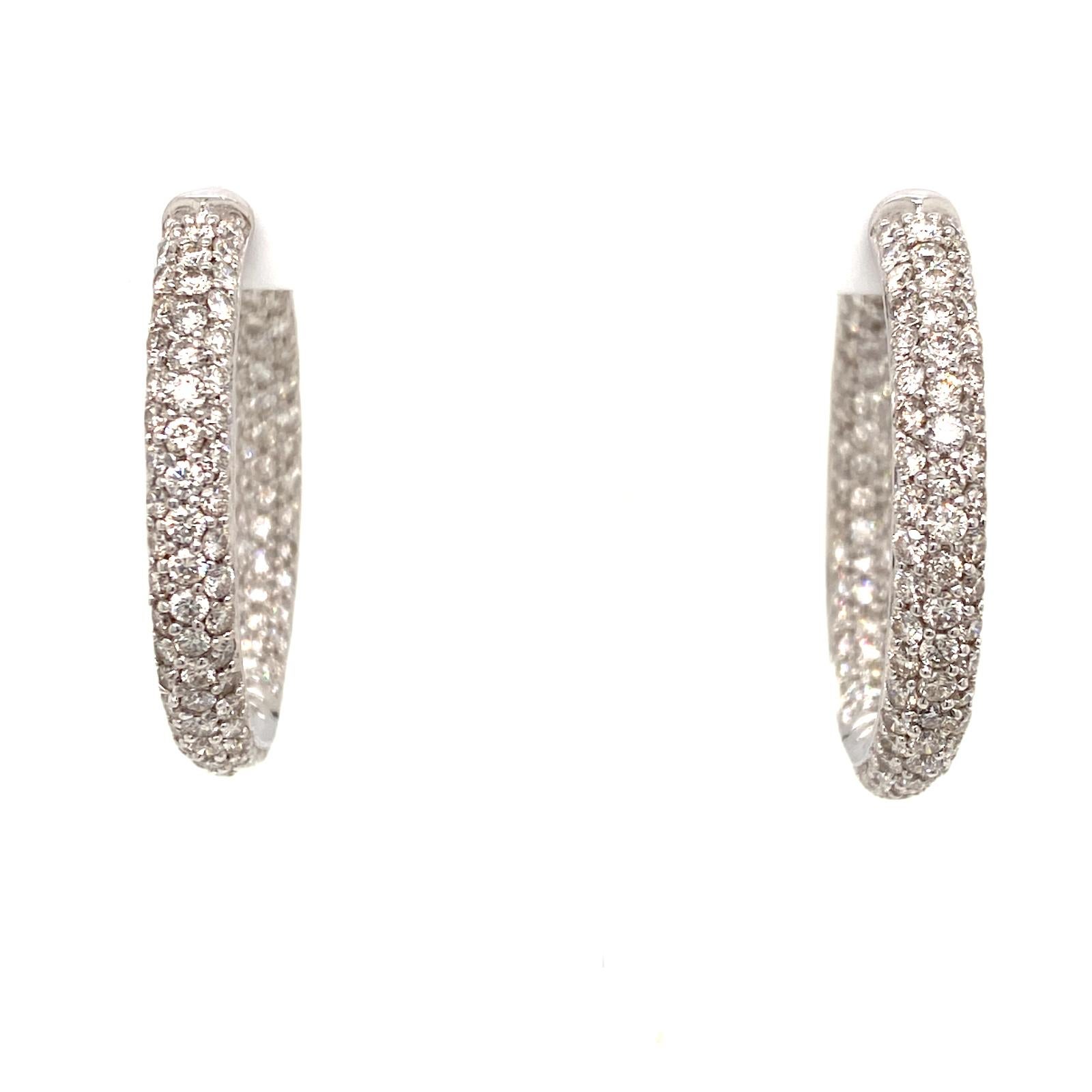 Beautiful diamond in & out hoop earrings fashioned in 18 karat white gold. The hoops feature 5.00 carats of round brilliant cut white diamonds graded G-H color and VS clarity. The hoops measure 1.25 inches in diameter, and 4.5mm in width