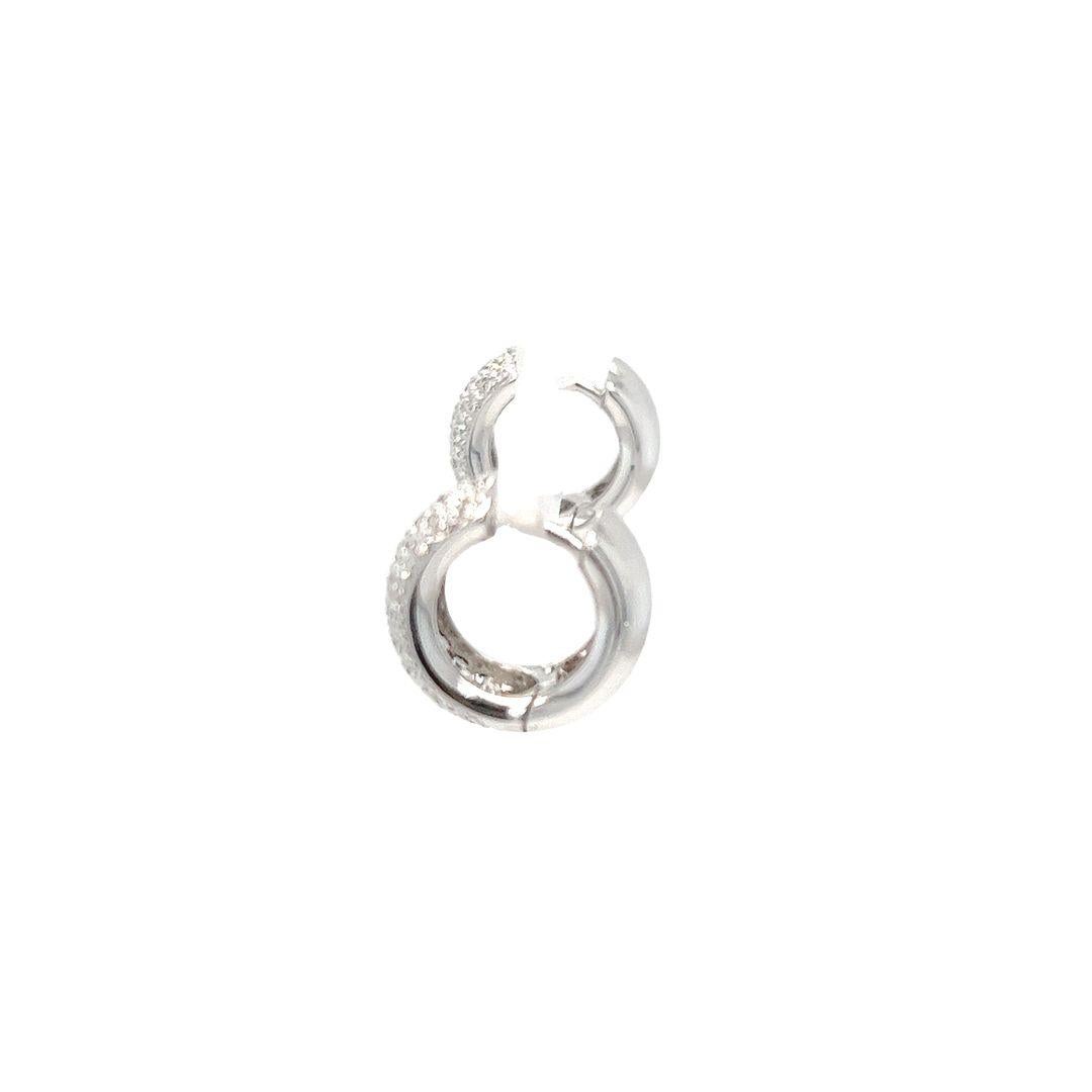 18 Karat White Gold Micropave Diamond Huggie Earrings Featuring 100 Round Brilliant Cut Diamonds of VS Clarity and G Color Totaling Approximately 0.50 Carats. 6mm Wide with 9mm Interior Diameter. Pierced Post with Hinged Clip Back. Finished Weight