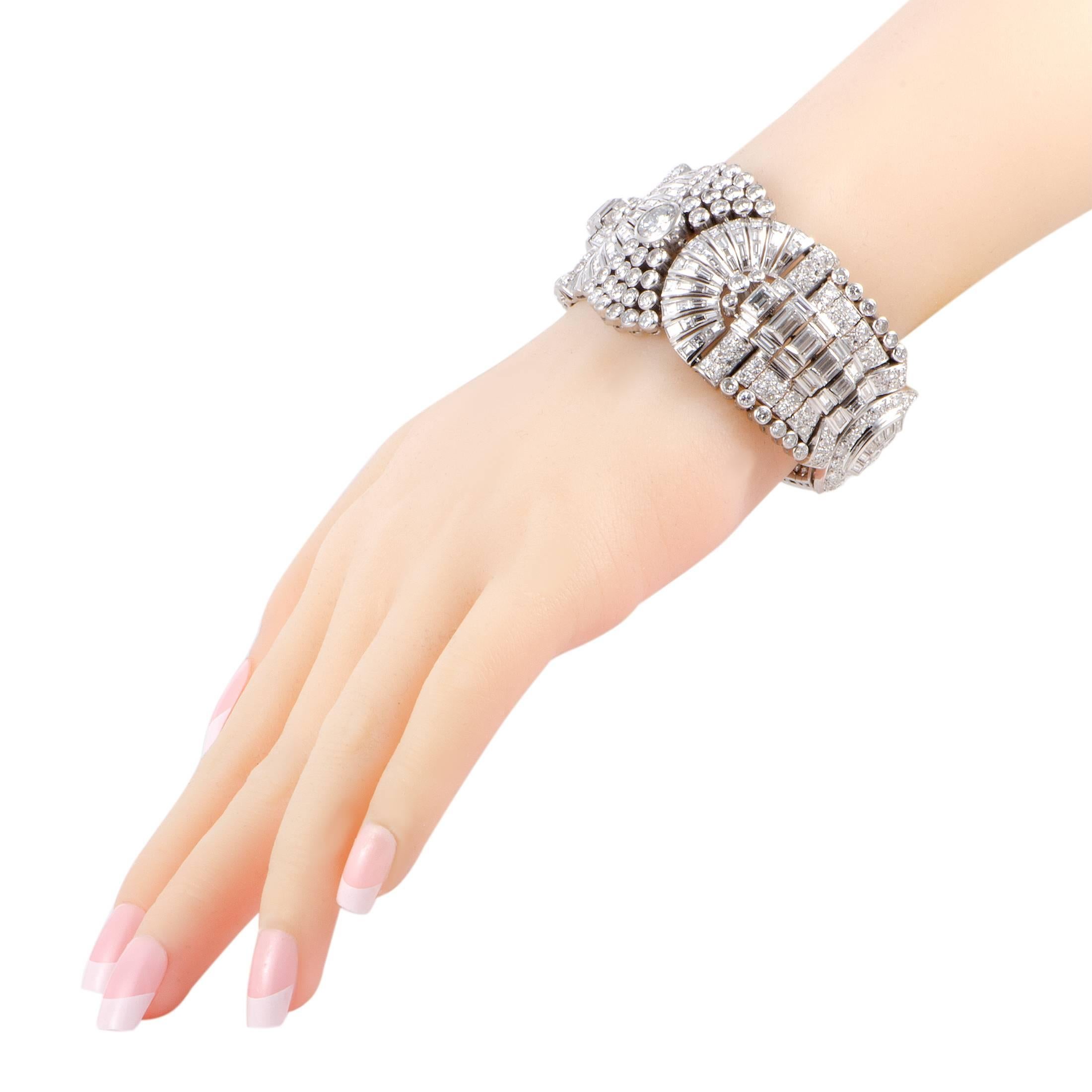 Lustrous extravagance is embodied at its finest in this spectacular bracelet that is masterfully crafted from prestigious platinum whose alluring sheen presents a perfect backdrop for the plethora of luxuriously resplendent diamonds. The center