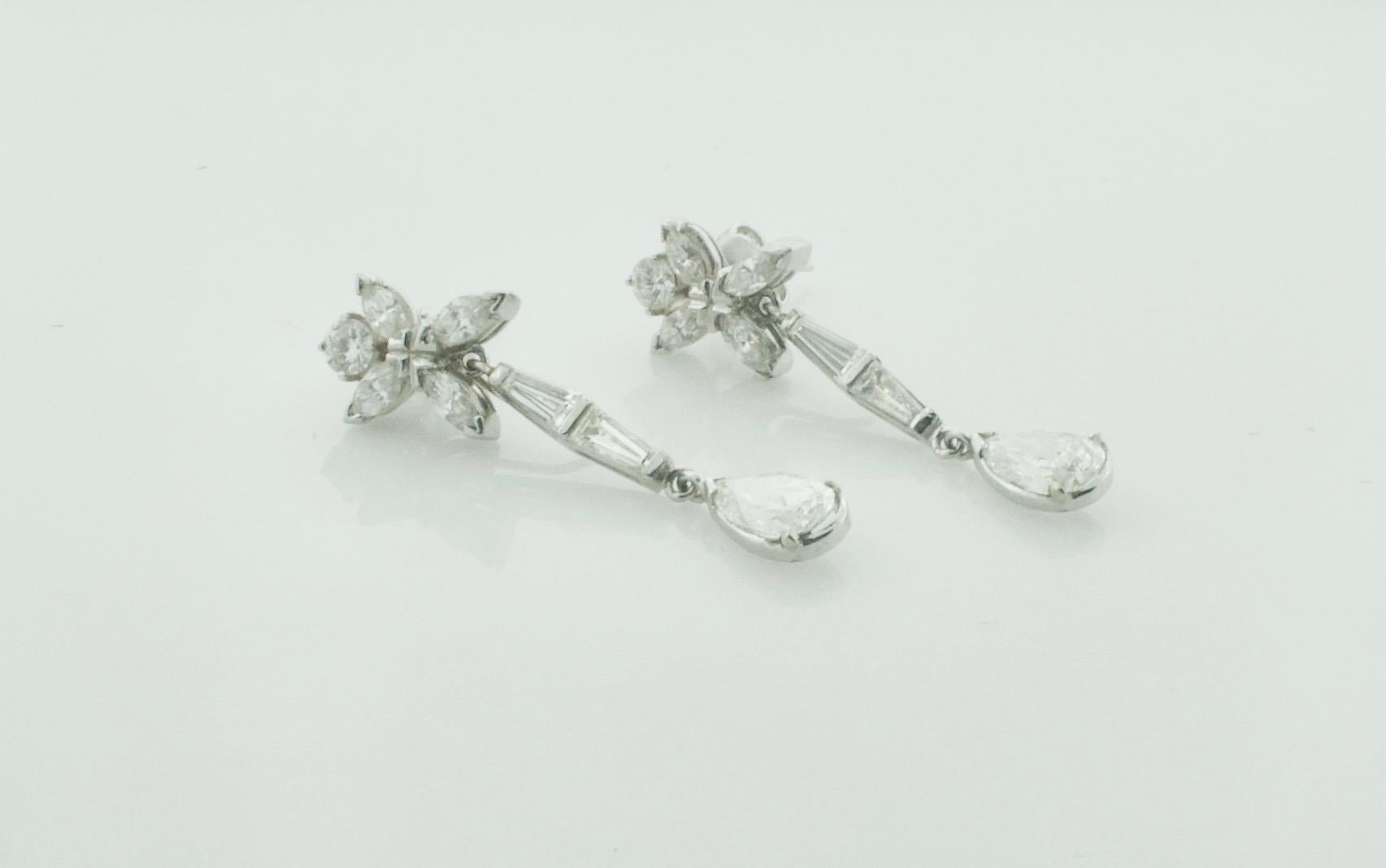 Diamond Pear Shape Drop Earrings in Platinum Circa 1950's
A Must Have For Your or Your's Jewelry Collection
Dangling and Articulated Throughout
2 Pear Shape Cut Diamonds Weighing 2.05 Carats [GIA Certified]
 14 Round Brilliant, Tapered Baguette and