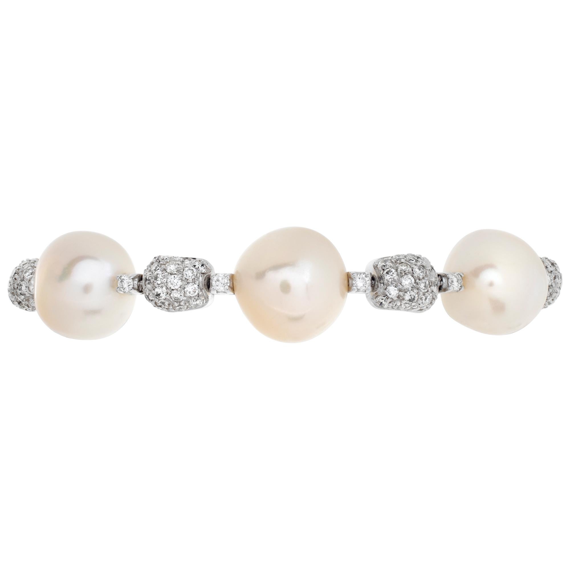 Diamond pearl bangle in 18k white gold with silver and pink overtones and approximately 1.5 carats in G-H color VS clarity. Fits from 6