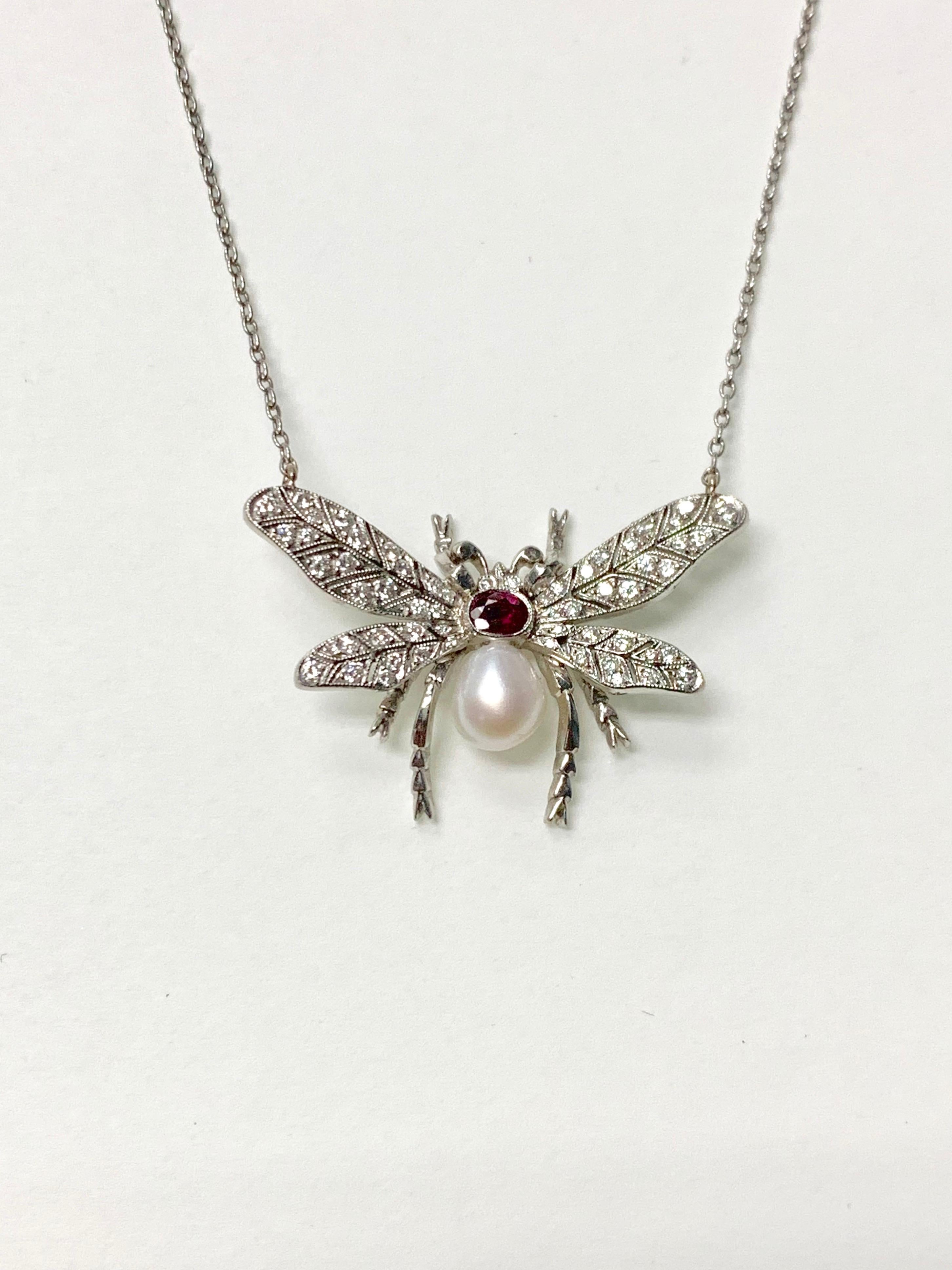 Diamond pearl and rubies bumblebee necklace beautifully handcrafted in platinum. 
Diamond weight: 0.40 carat 
Ruby weight : 0.25 carat 
metal : platinum 
measurements: 1 1/4 by 1 inch 