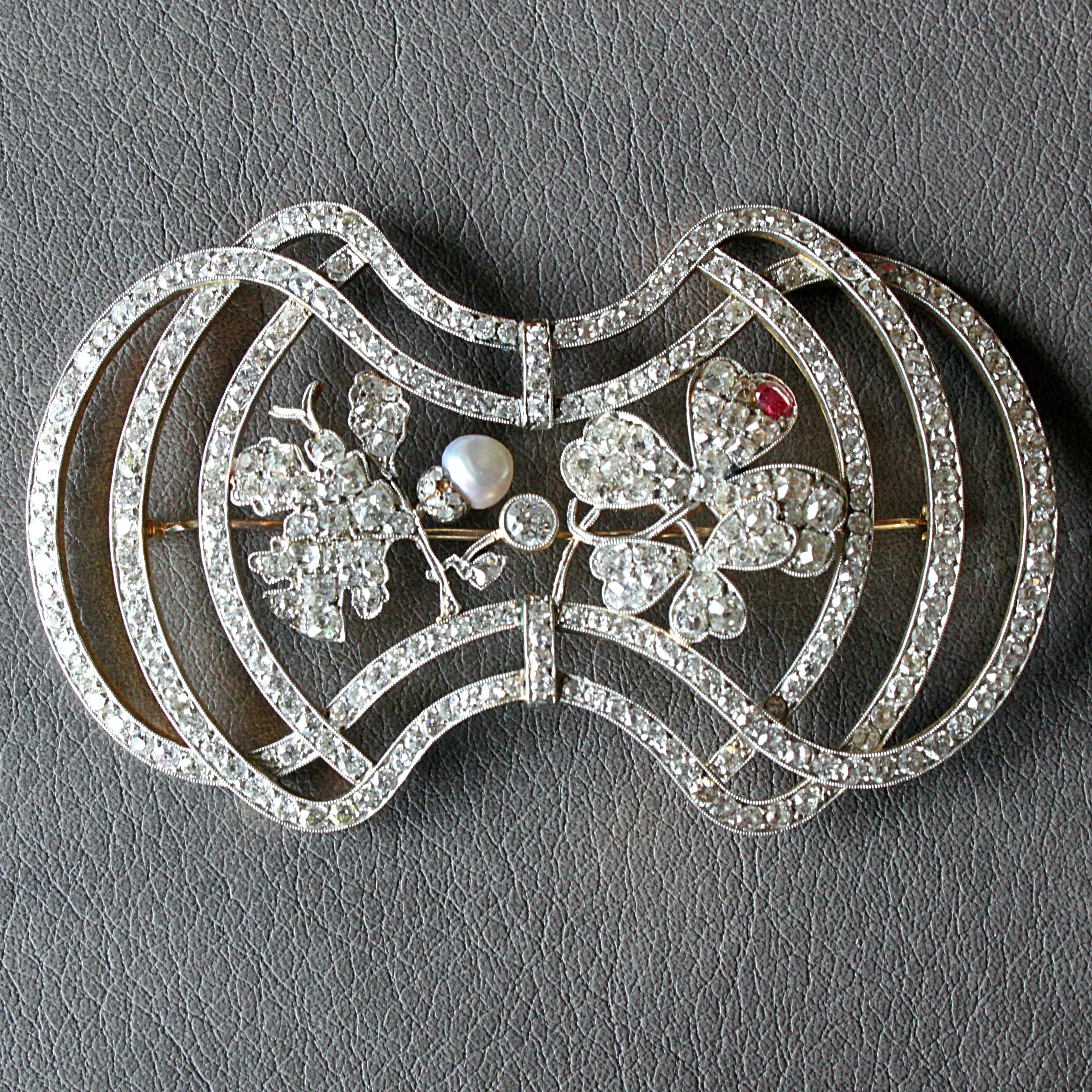 A large diamond, pearl and ruby Art Nouveau brooch in platinum and yellow gold, ca. 1910s. 

It has a beautiful design and with the depiction of an oak leaf and trefoil clover it carries strong symbolism. The brooch is very finely set with numerous
