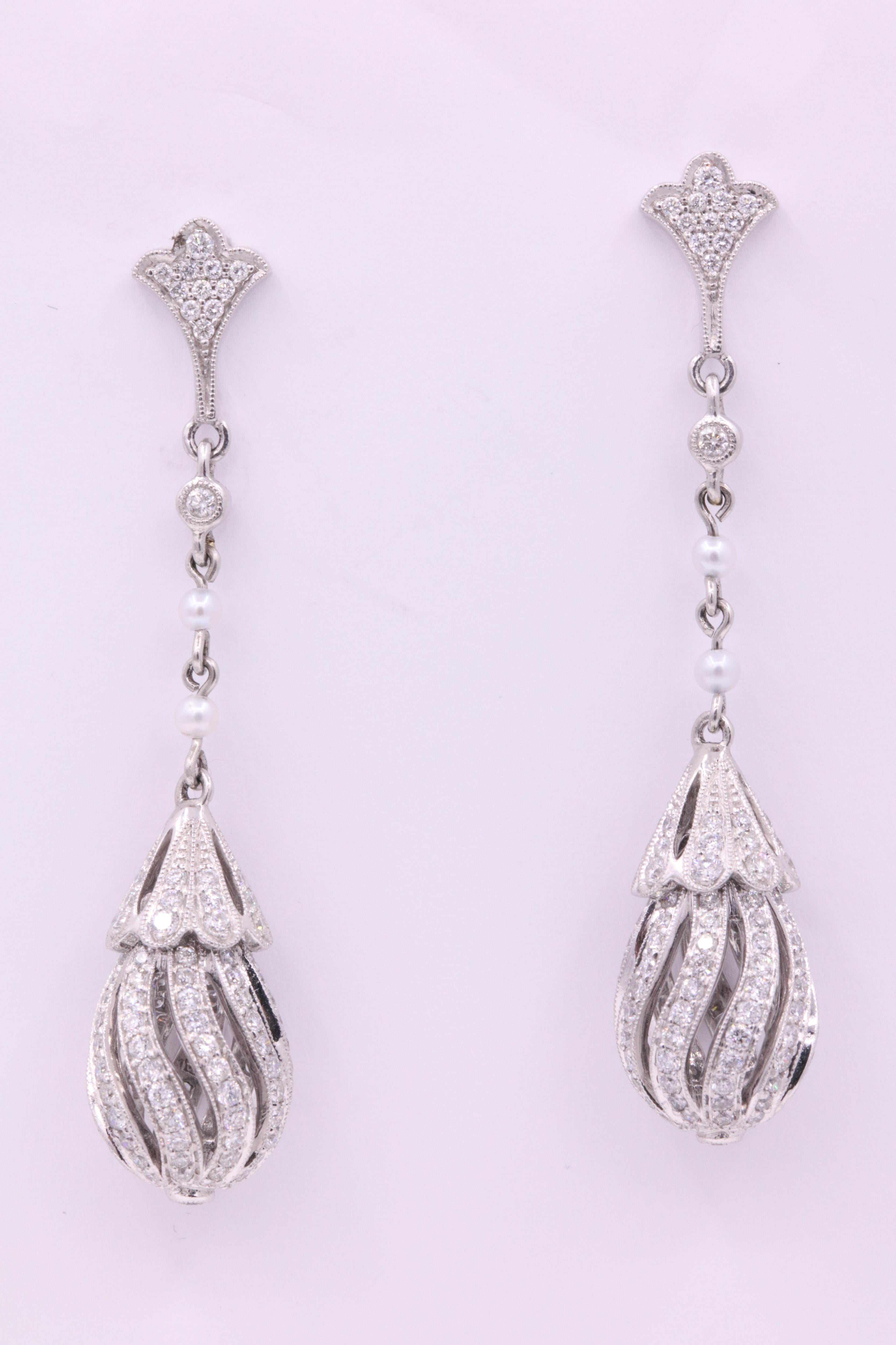 Art Deco style earrings featuring round brilliants weighing 2.71 carats with touches of white pearls, crafted in platinum. 
Color G
Clarity SI