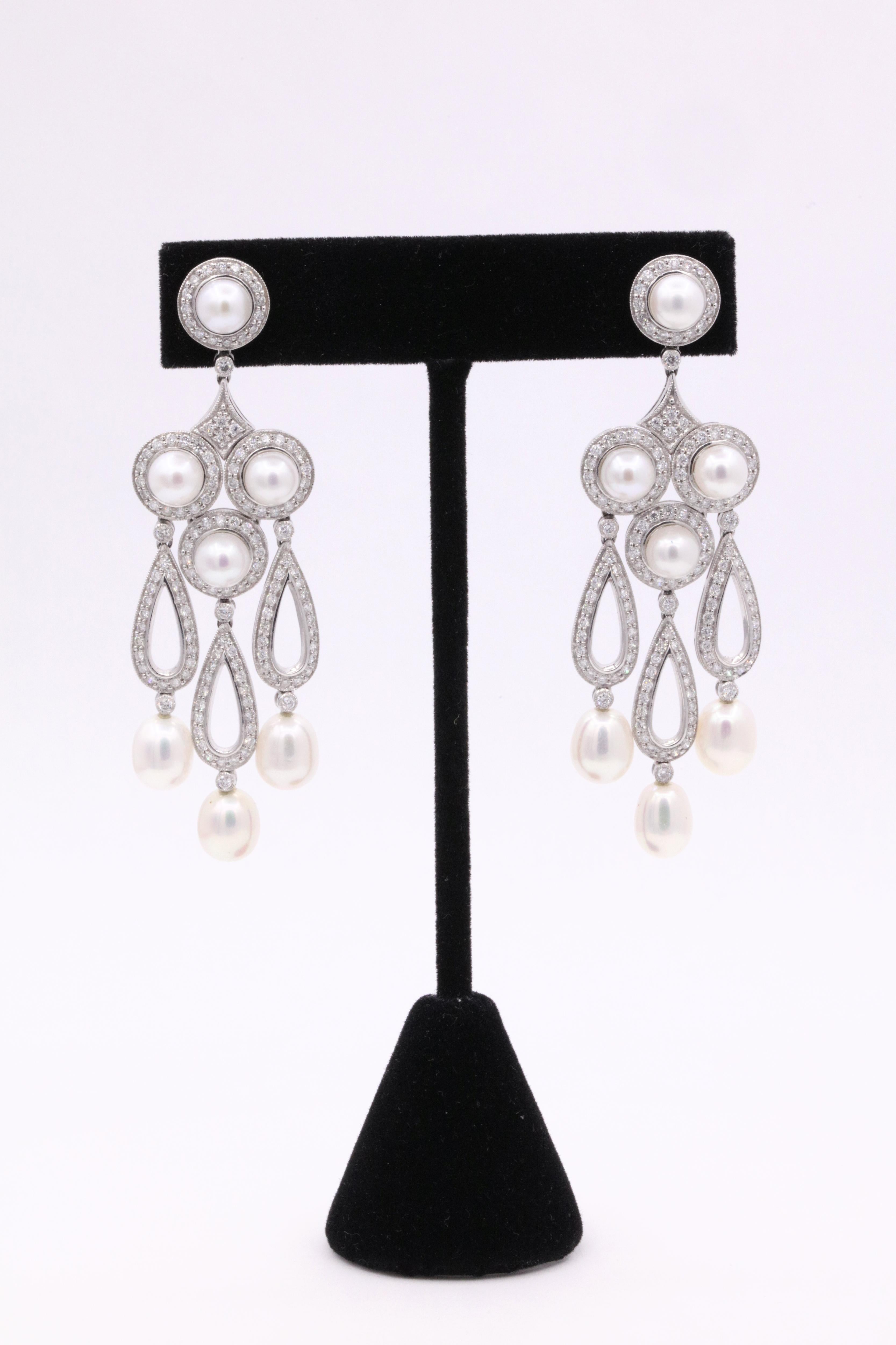 Art Deco inspired earrings featuring round brilliants weighing 3.13 carats with touches of round and oval shape pearls. 
Color G
Clarity SI
A real show stopper!