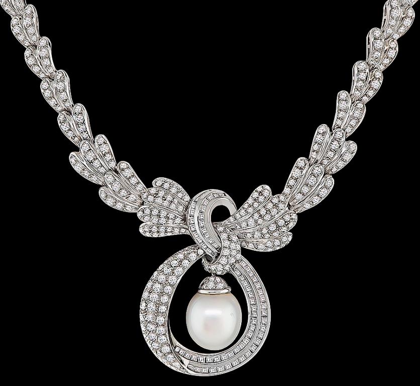 This magnificent 18k white gold necklace is set with sparkling round and carre cut diamonds that weigh approximately 8.00ct. graded G-H color with VS clarity. The diamonds are accentuated by a lovely pearl in the center.
The necklace measures 17