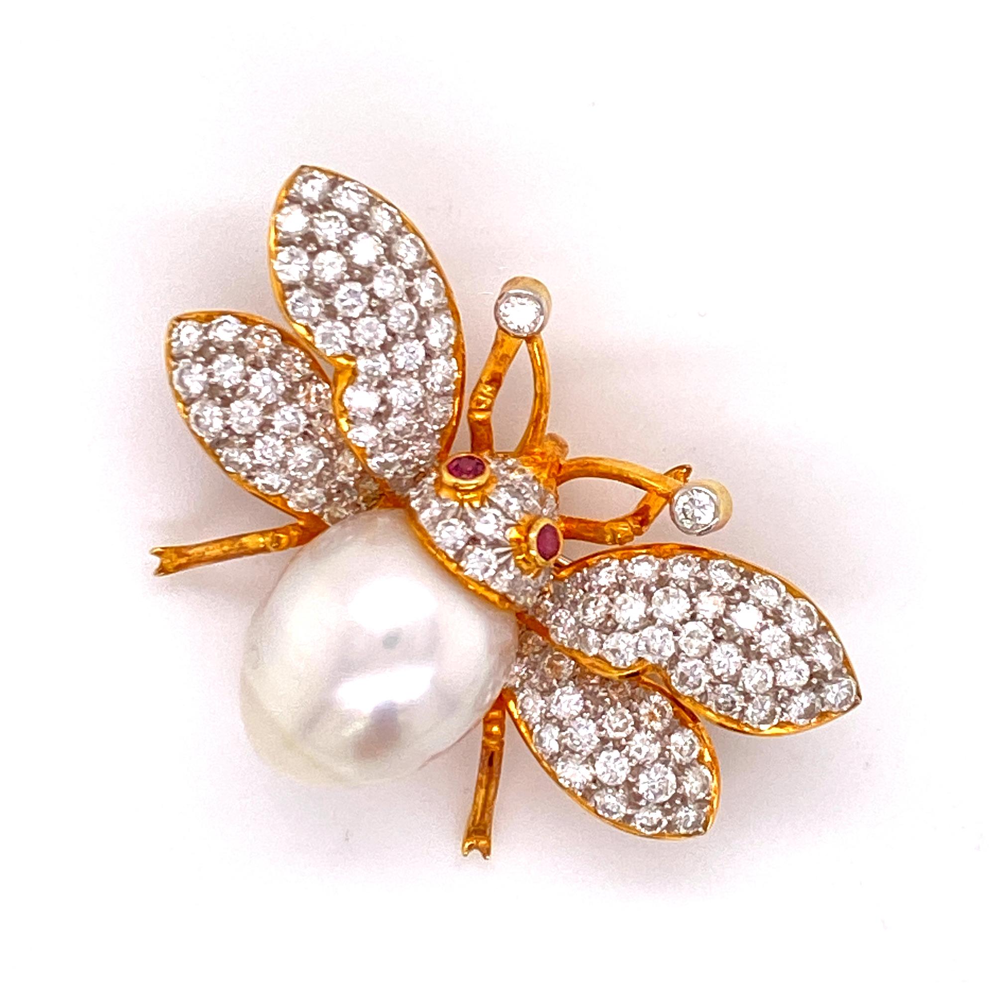 Beautifully hand crafted diamond pearl bumble bee with vivid ruby eyes. The bee features high quality round brilliant cut diamonds weighing approximately 3.00 carat total weight and graded F-G color and VS clarity. The brooch has already been