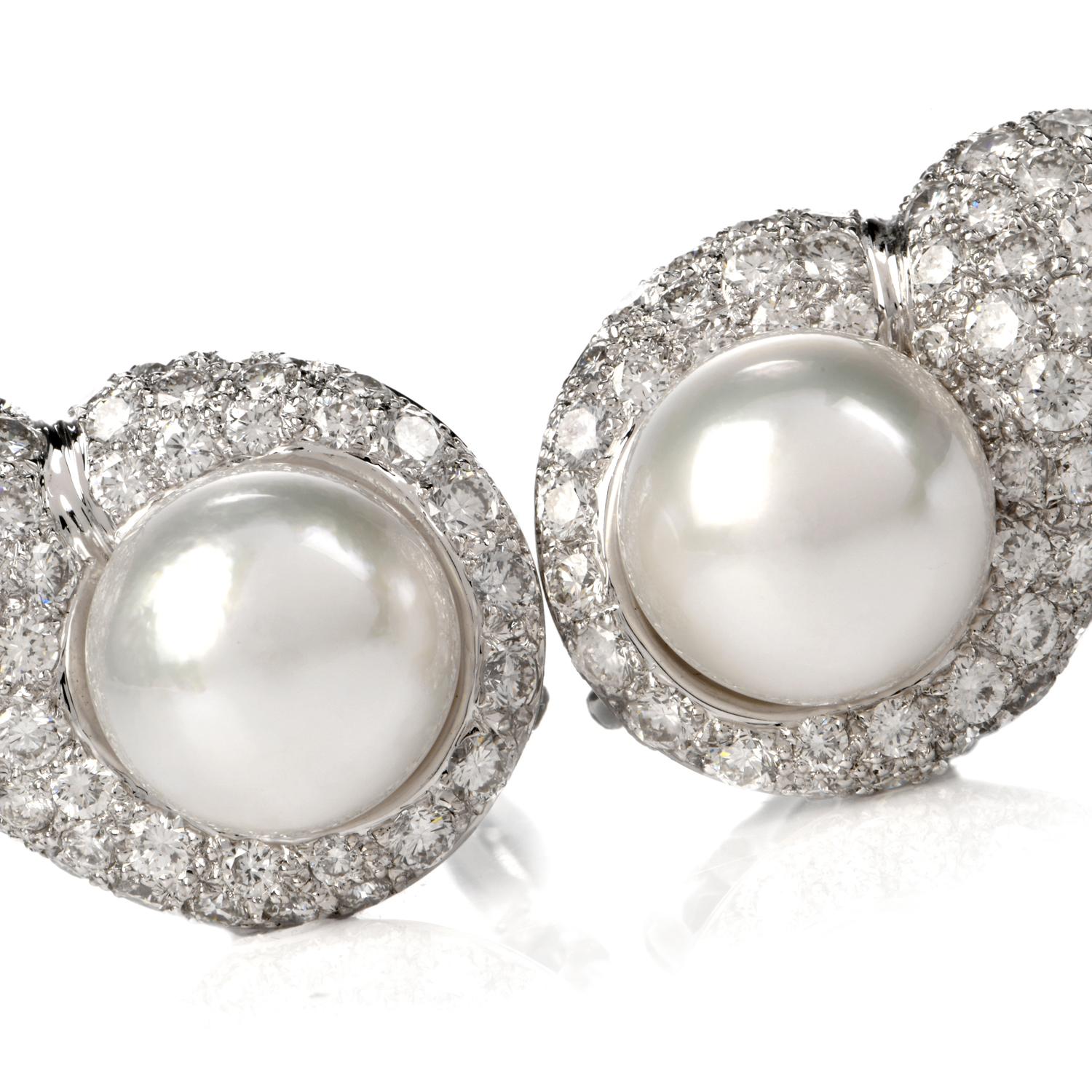 These elegant diamond and pearl tear drop shaped clip on earrings are crafted in solid 18 karat white gold, weighing 23.6 grams and measuring 30mm x 20mm. Showcasing a pair of prominent lustrous cultured pearls in white creamy color and measuring