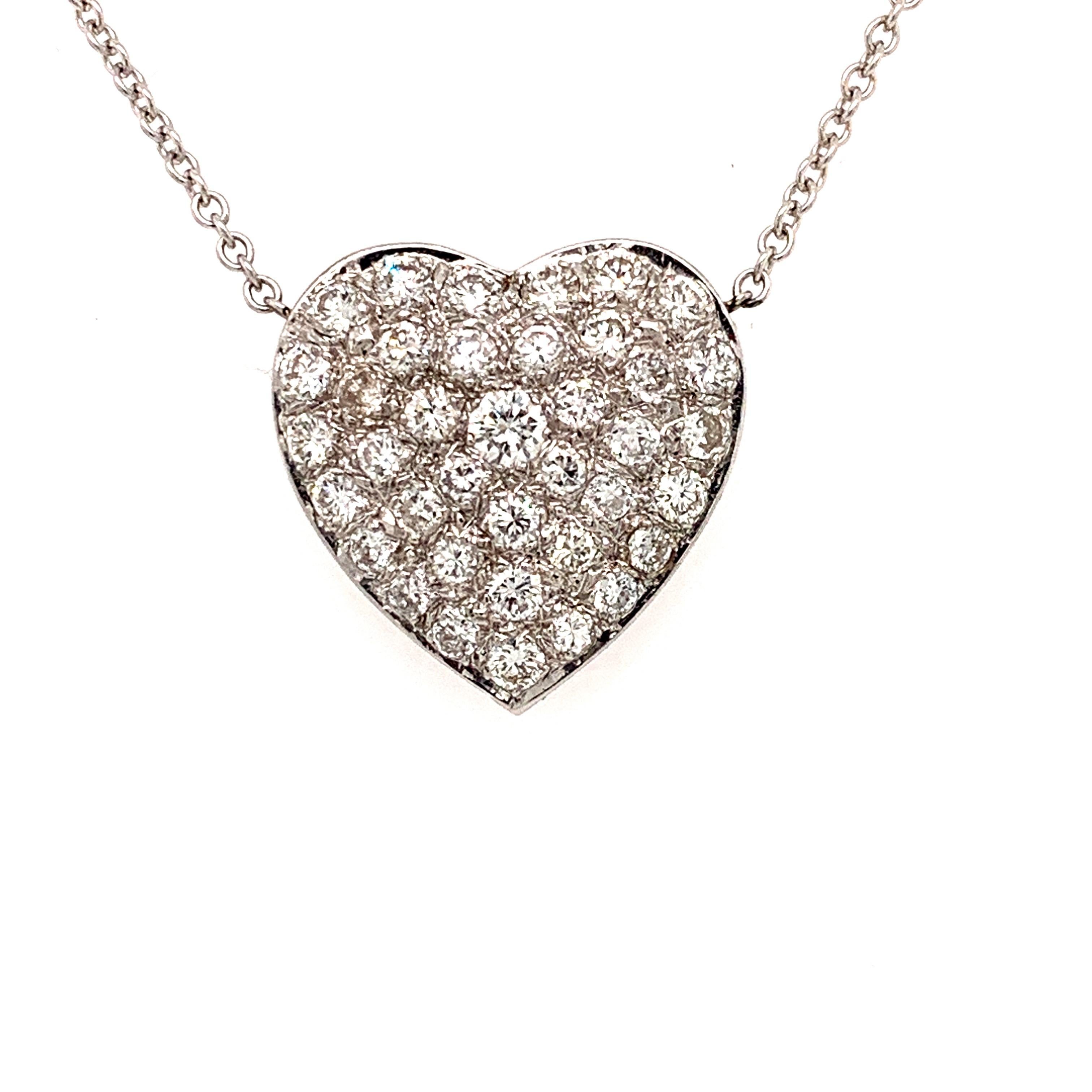This shimmering pendant necklace in heart shaped design. set with over four carats of ideal cut round brilliant diamonds F-G color VS clarity.
Incredible craftsmanship is noticeable throughout, allowing for the maximum brilliance of these incredible